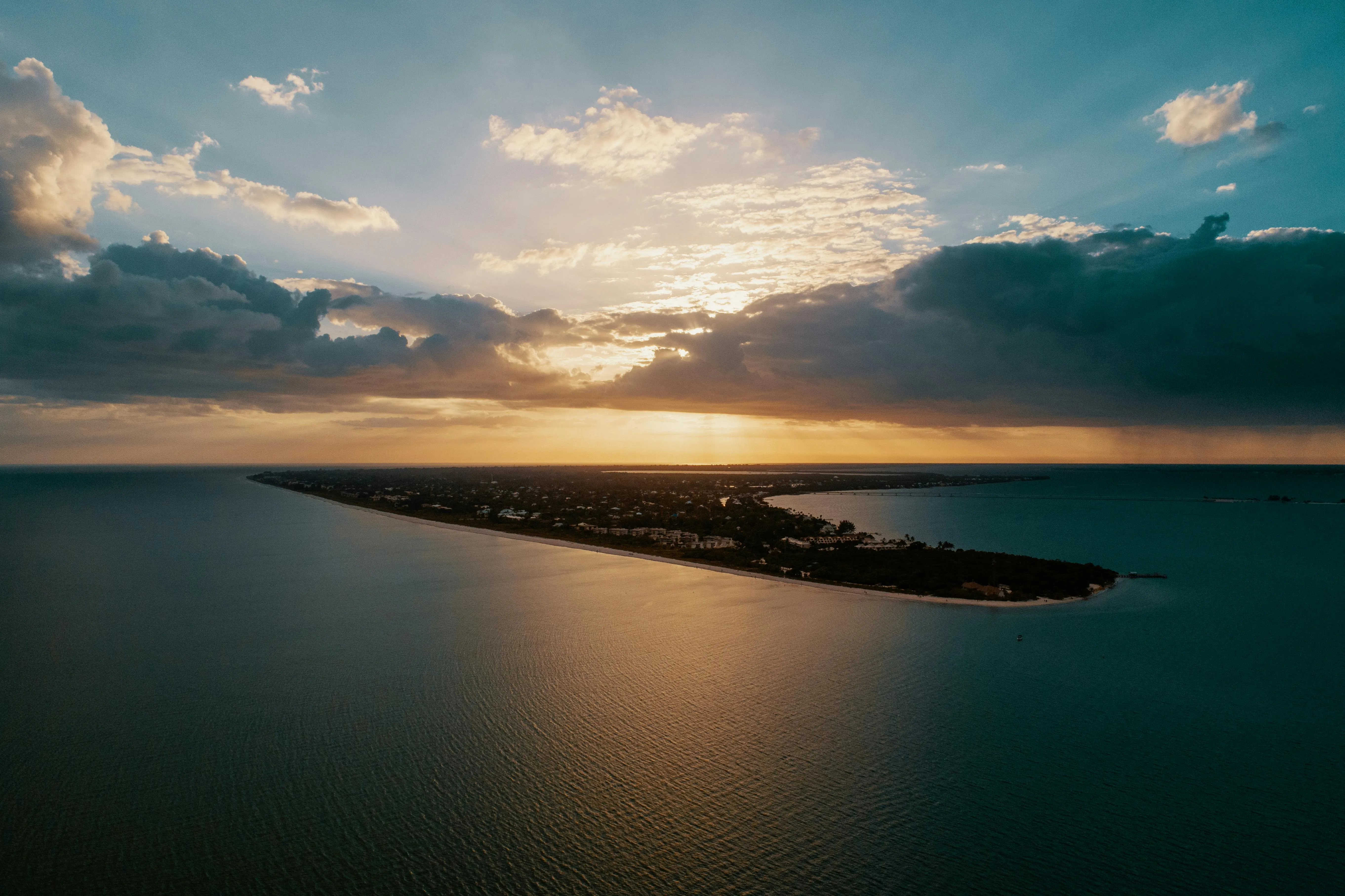 Golden Sunset Lighting Up a Thin Tropical Island in the Sea