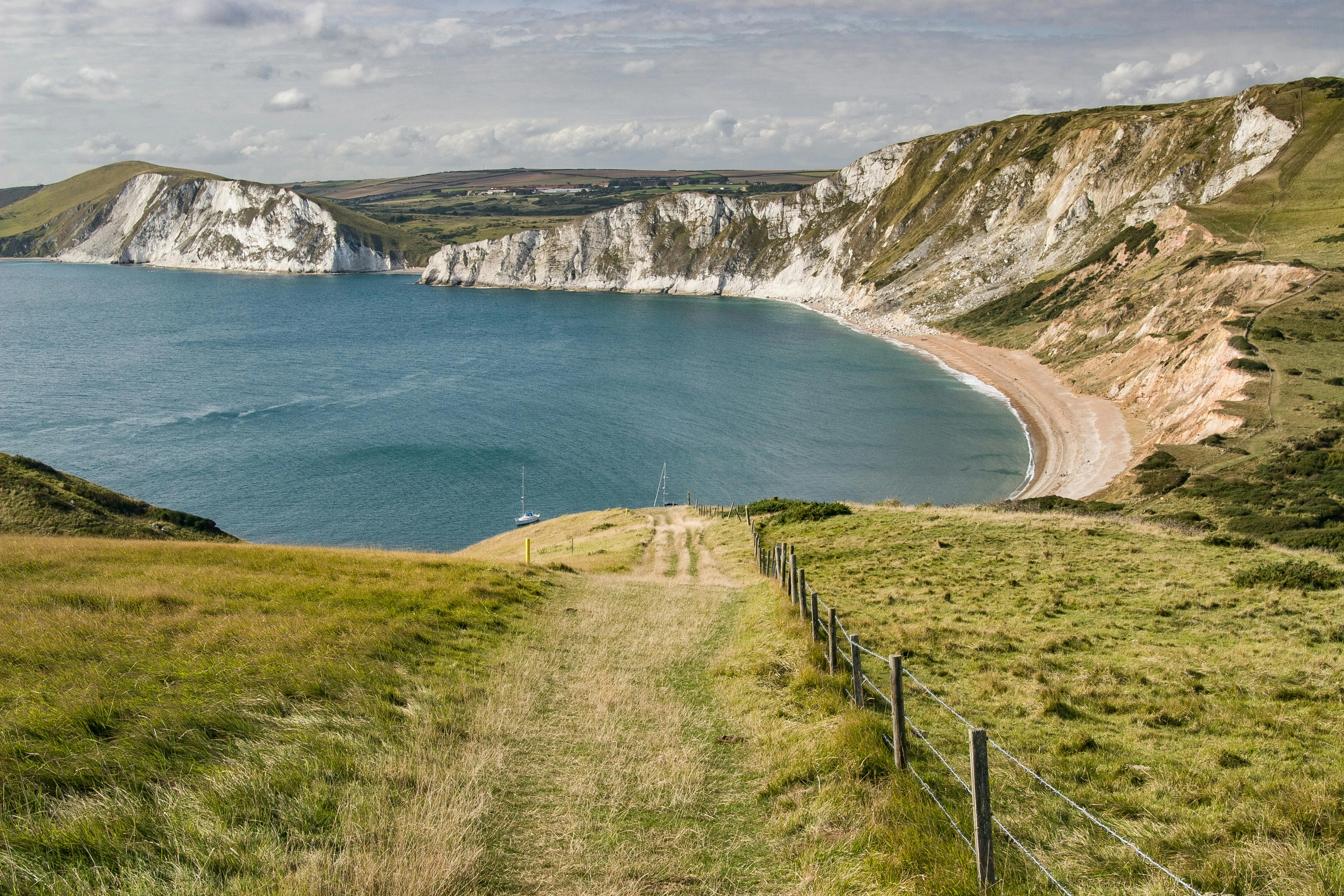 Grassy Cliffs with a Cloudy Sky Download Free Wallpaper