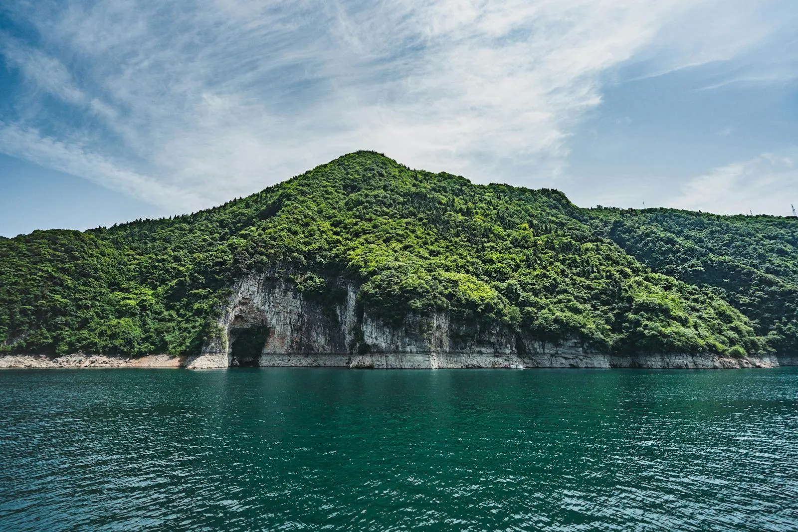 Green Island with a Cliff Edge and a Calm Ocean Wallpaper