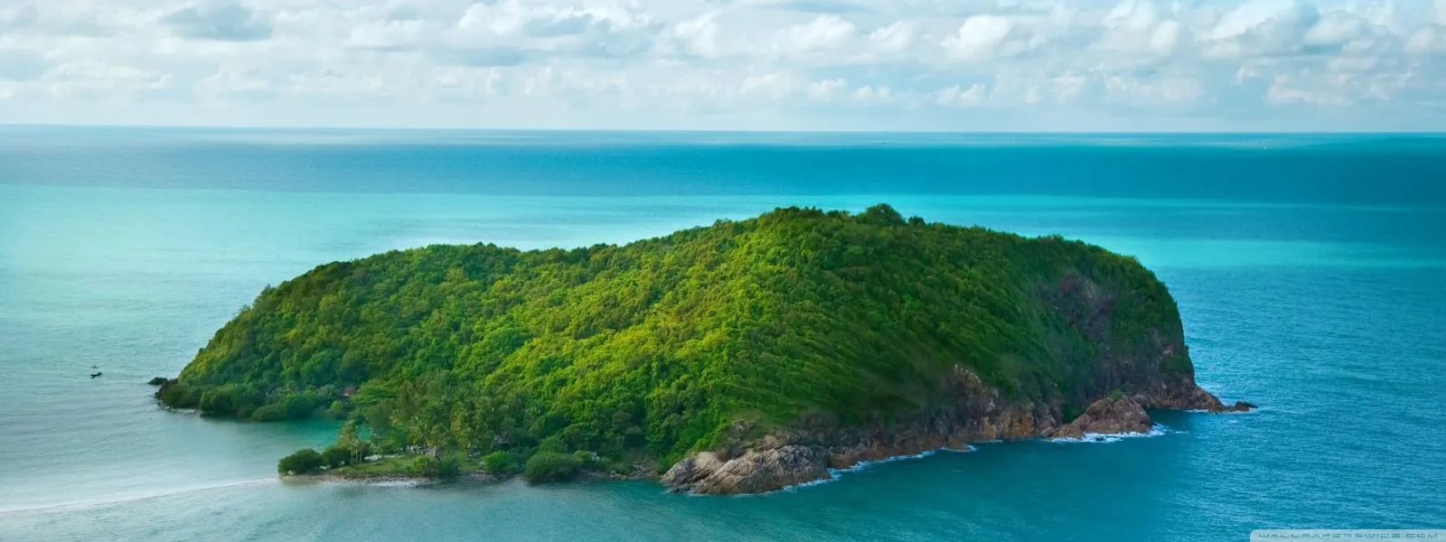 Green Island Surrounded by Ocean Under Blue Sky Wallpaper