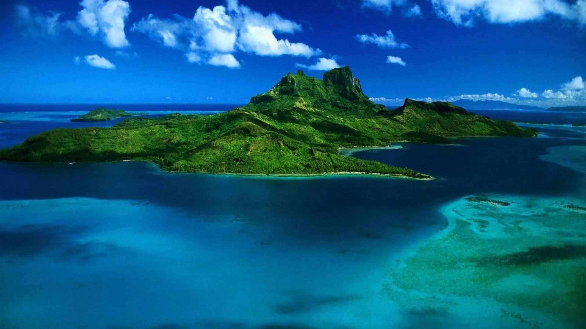 Island with Lush Green Hills Surrounded by Turquoise Water