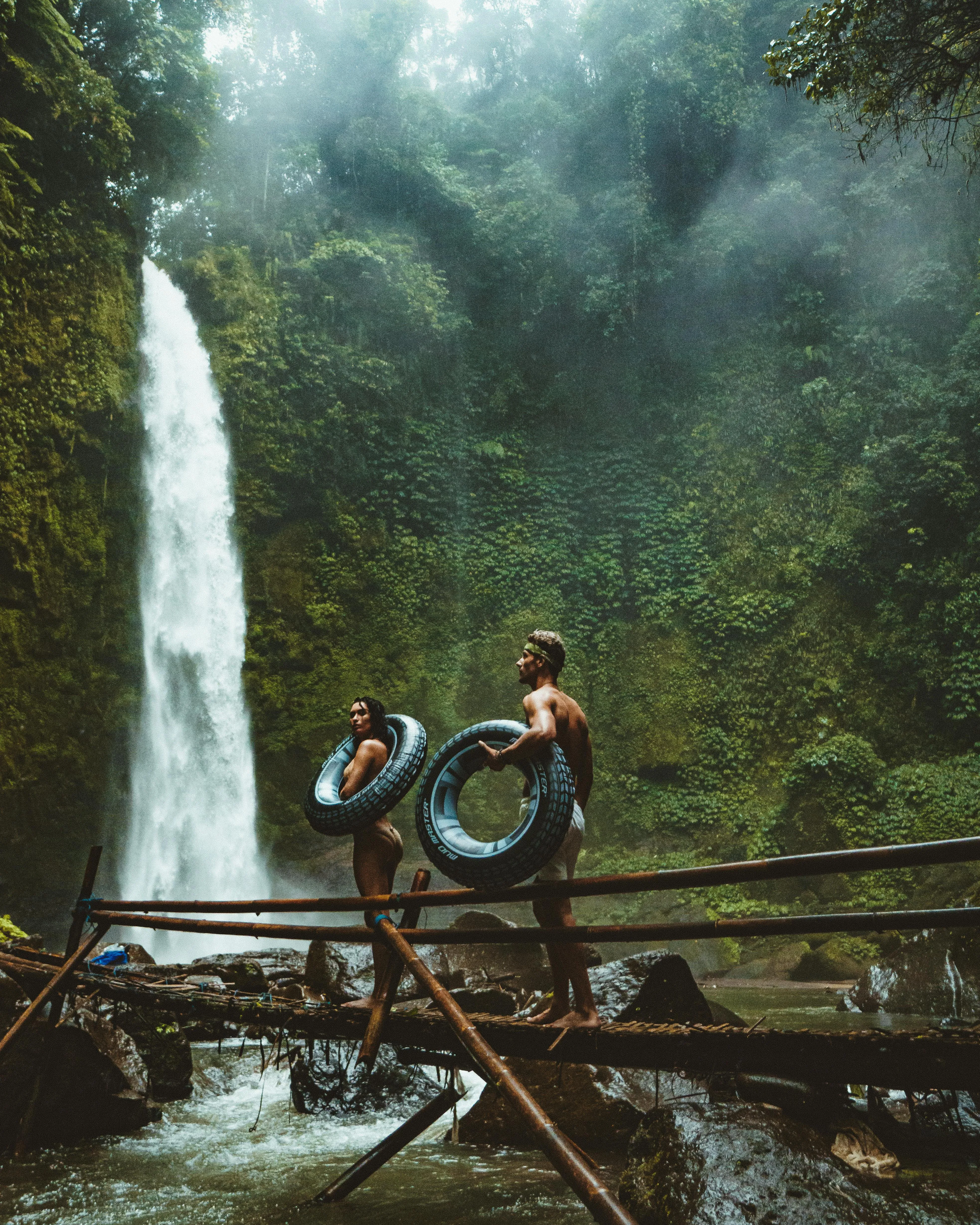 Jungle Waterfall with People Enjoying the Scenic Nature