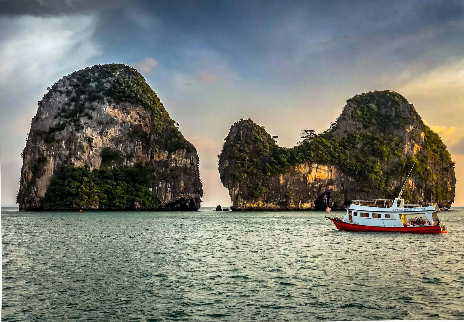 Limestone Cliffs and a Boat Floating on the Green Waters