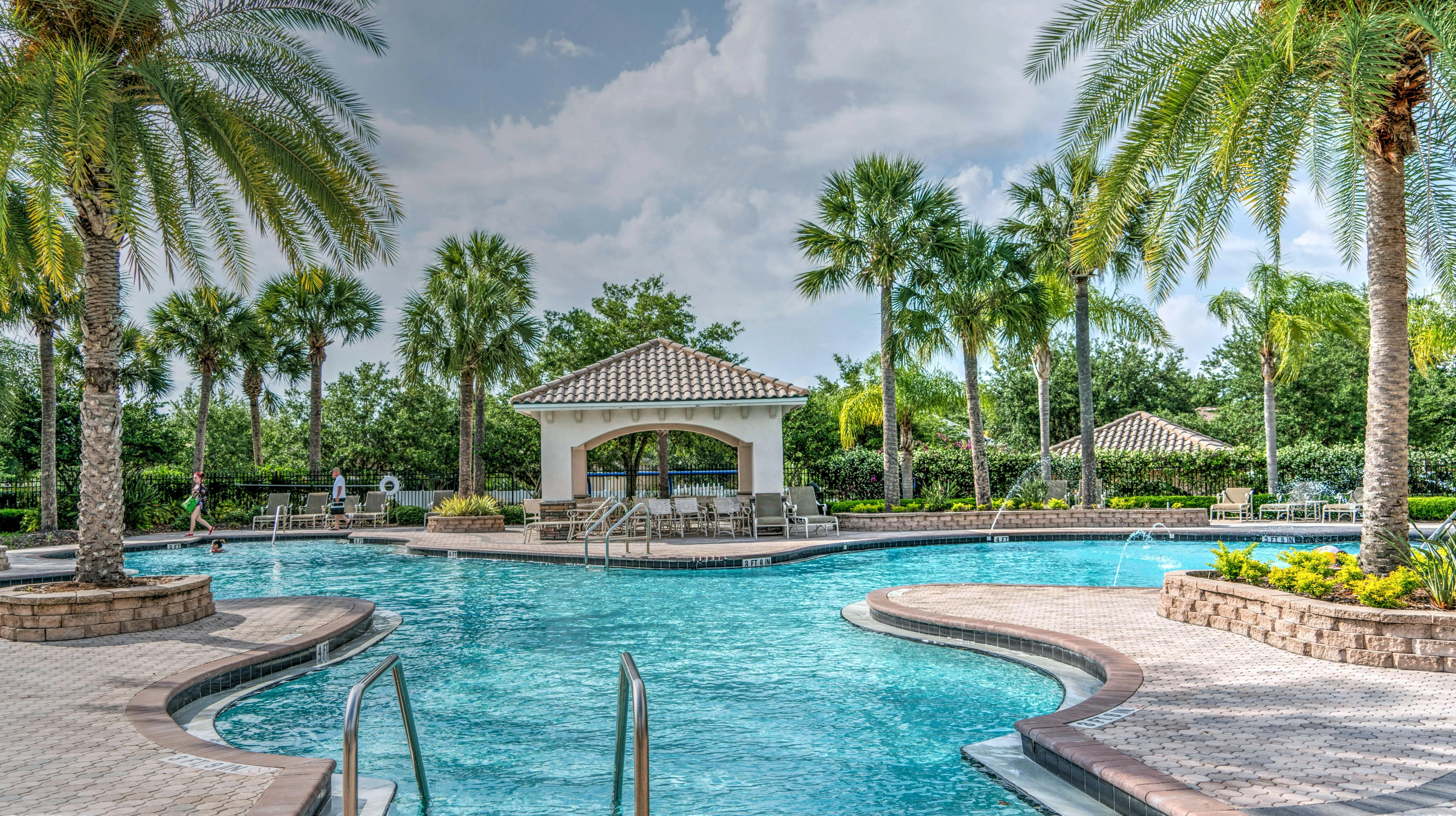 Luxury Tropical Poolside Framed with Palm Trees Wallpaper