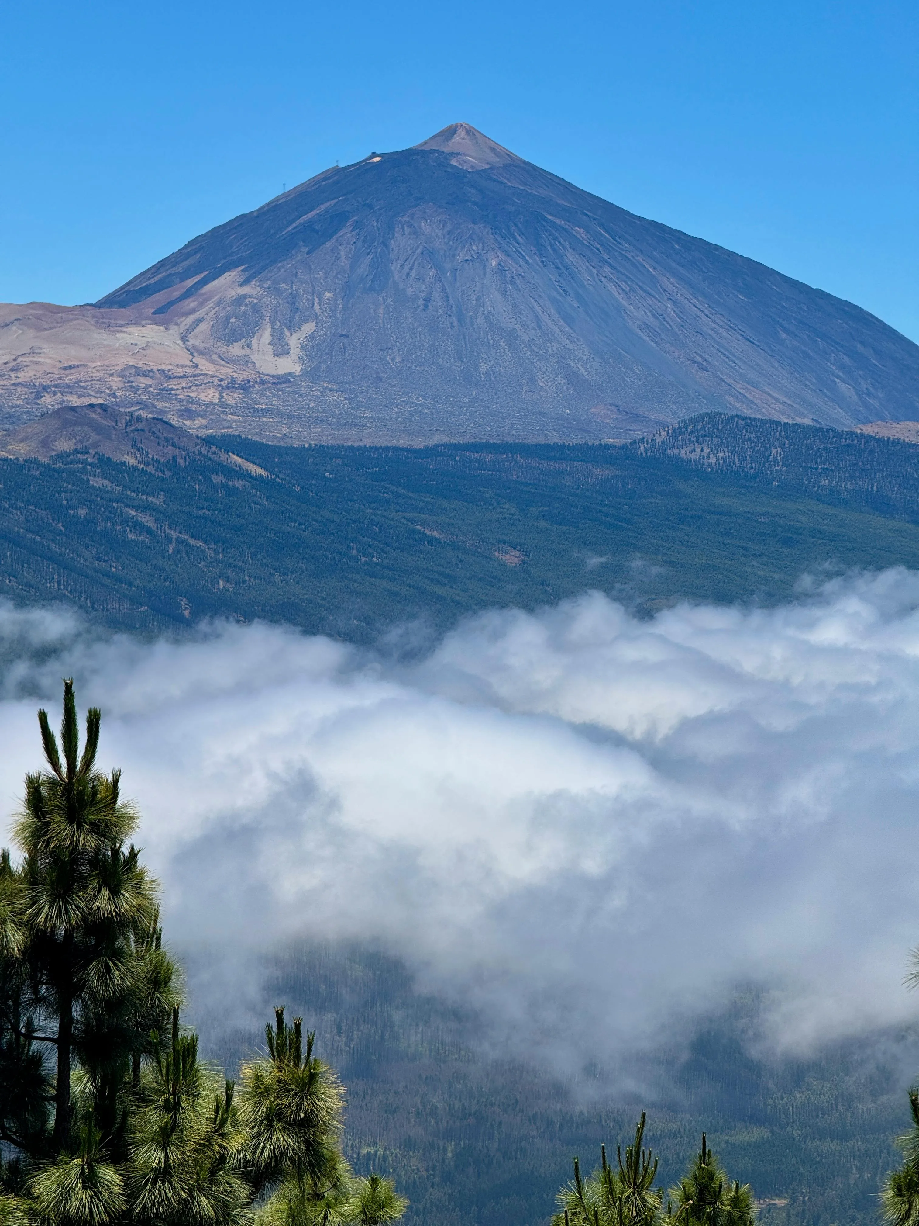 Majestic Mountain Peak Rising Above Soft White Clouds