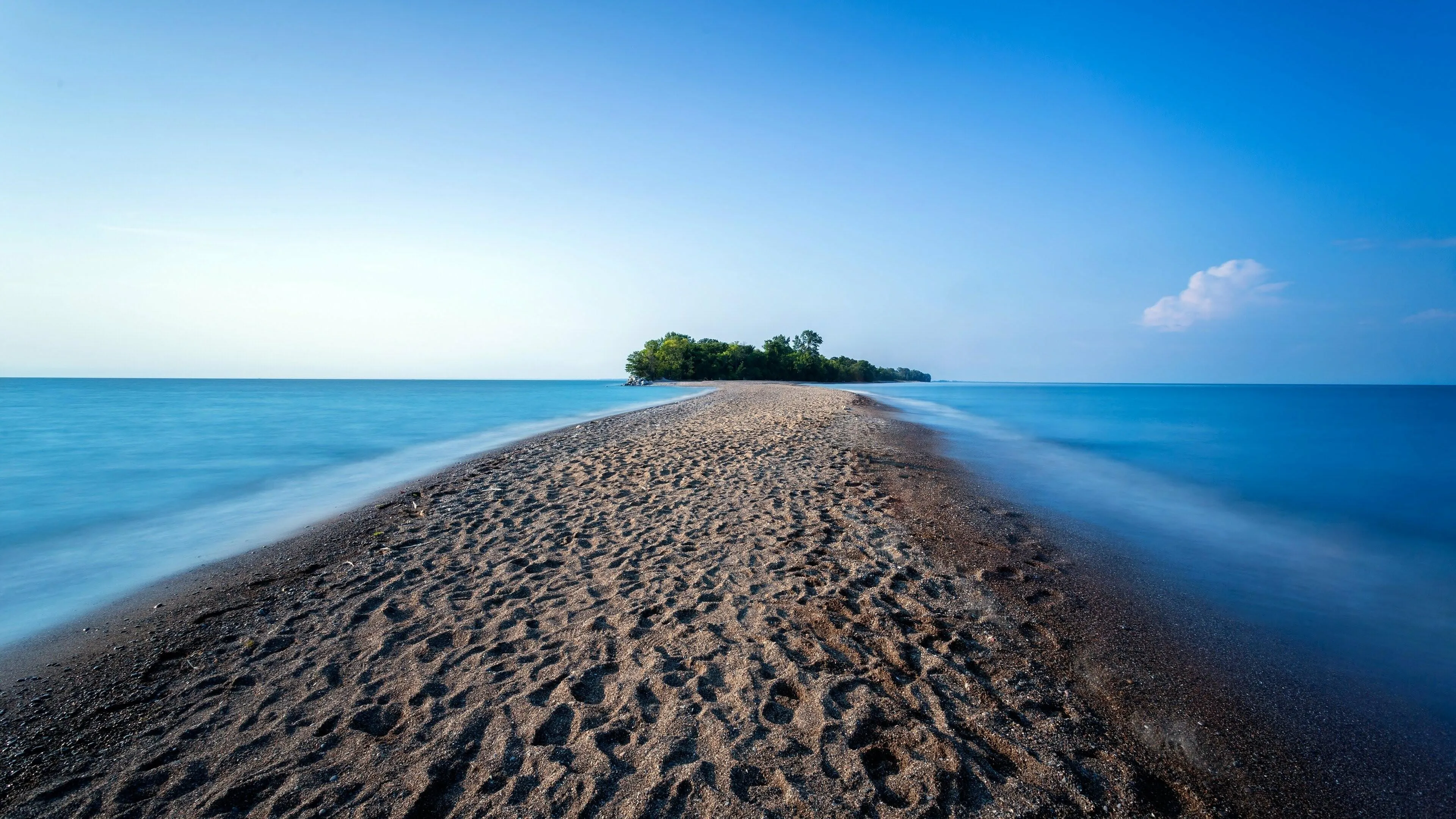 Narrow Black Sand Beach Between Two Vibrant Oceans Wallpaper