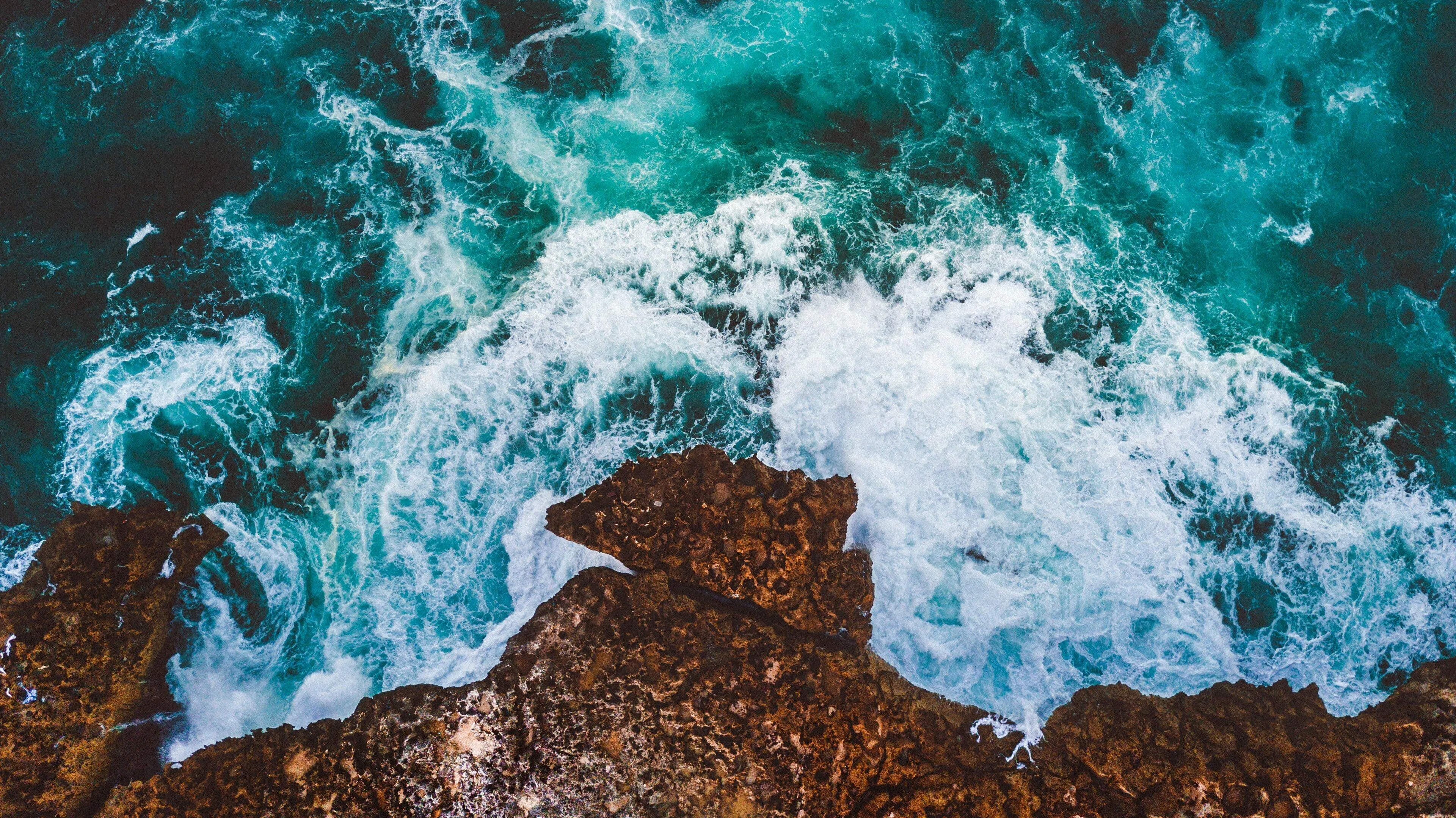 Ocean Waves Crashing Against Rocky Shoreline Wallpaper