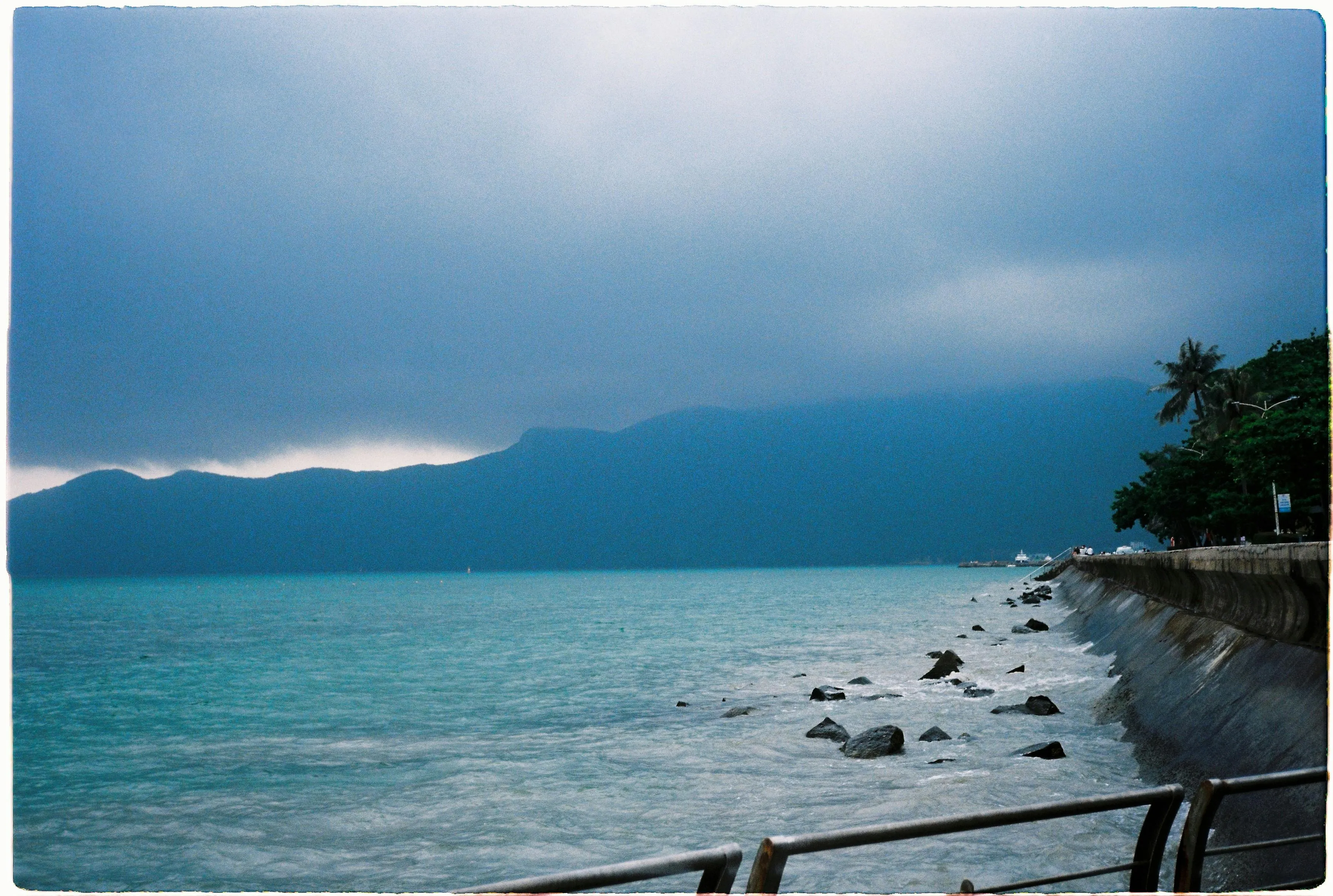 Oceanfront Road with a Dramatic Cloudy Sky Wallpaper