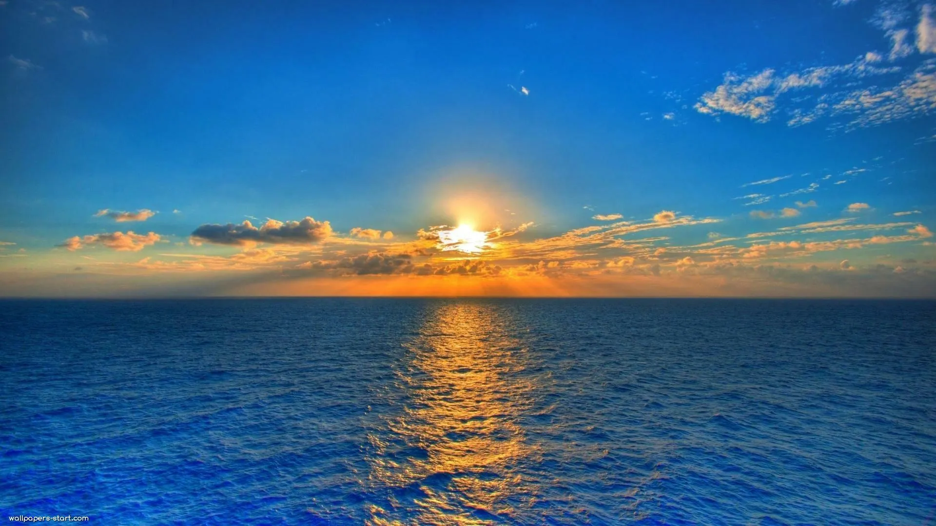 Orange Sunset Glowing over Calm Sea Download Free Wallpaper