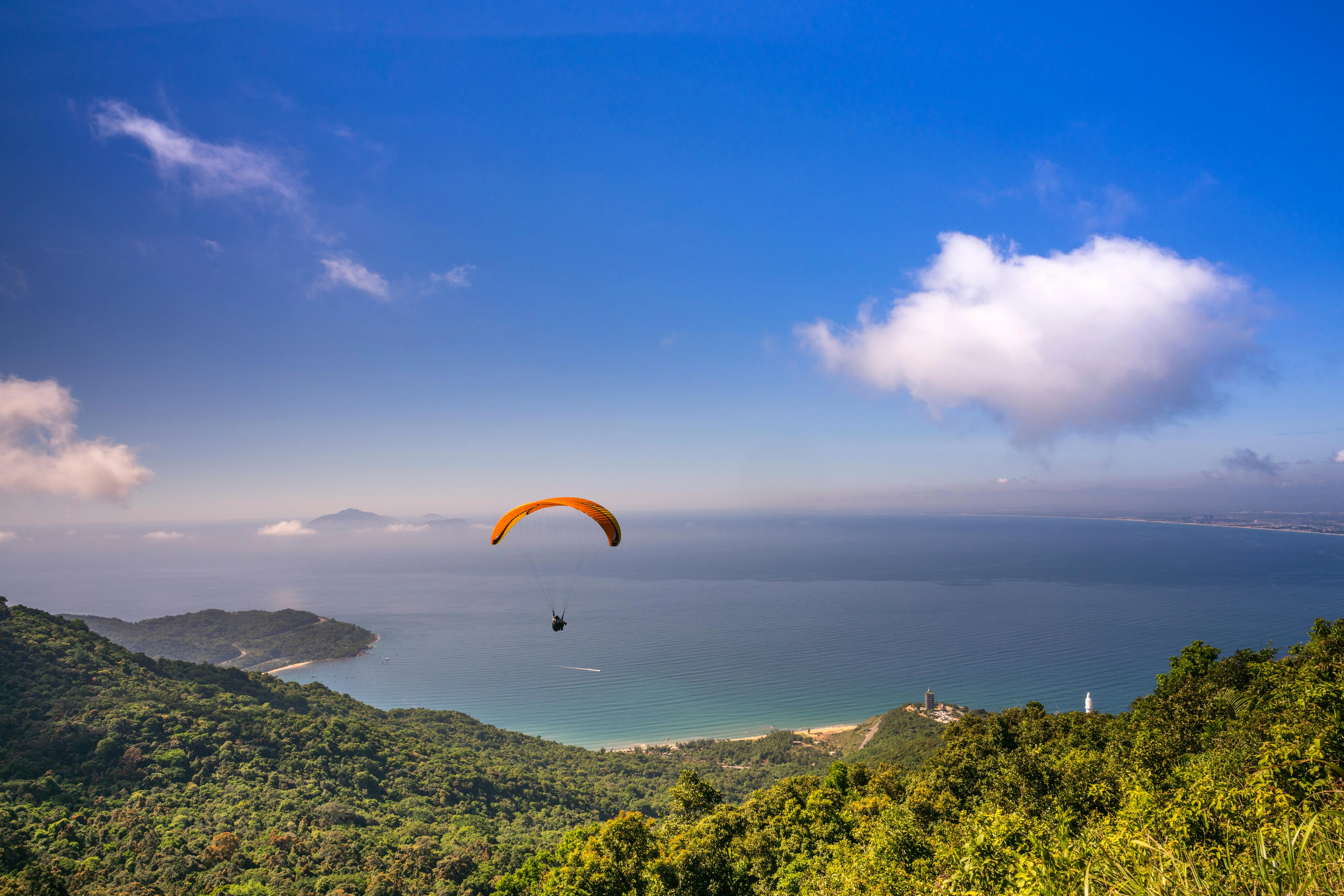 Paraglider over the Sea with Cliffs and Blue Sky Wallpaper