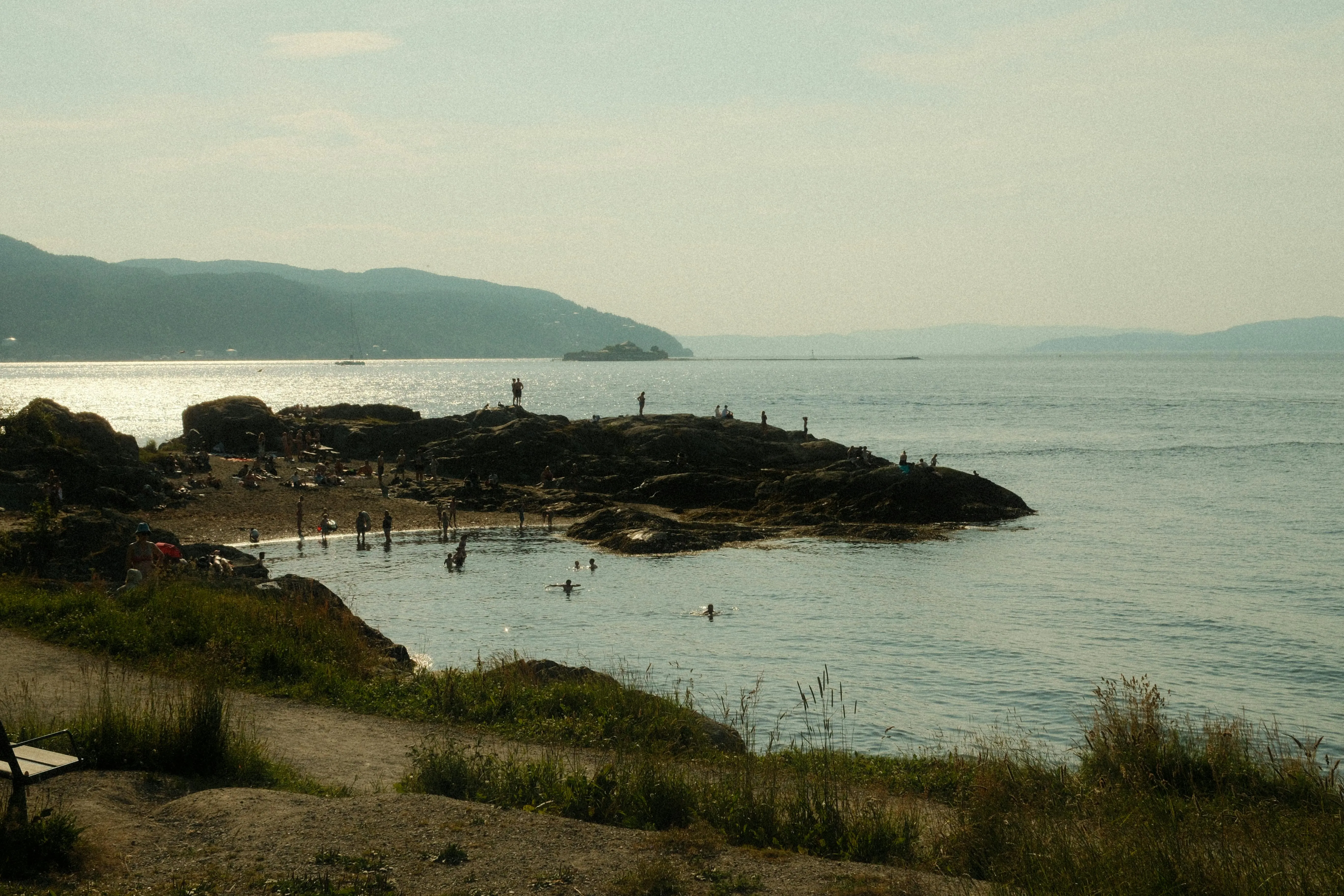 Peaceful Coastal View with Hills and Calm Waters Wallpaper