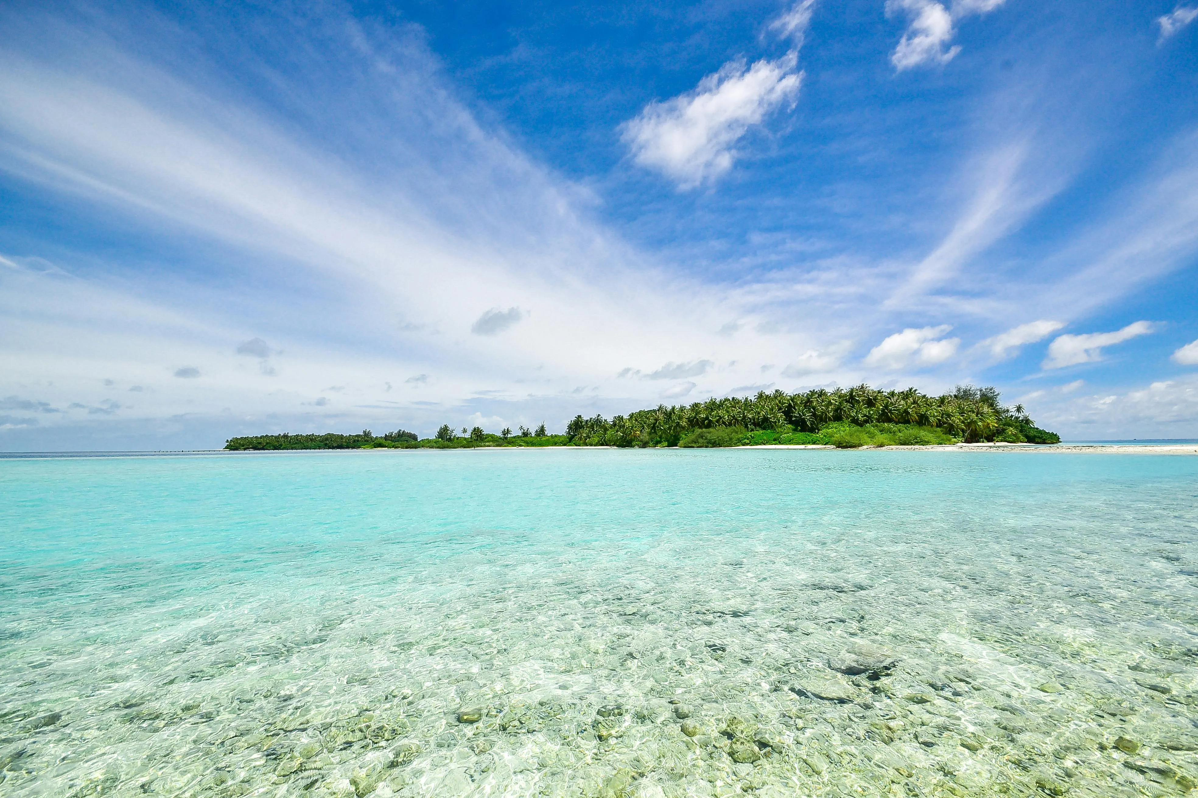 Peaceful Island with Crystal Clear Water and Sky Wallpaper
