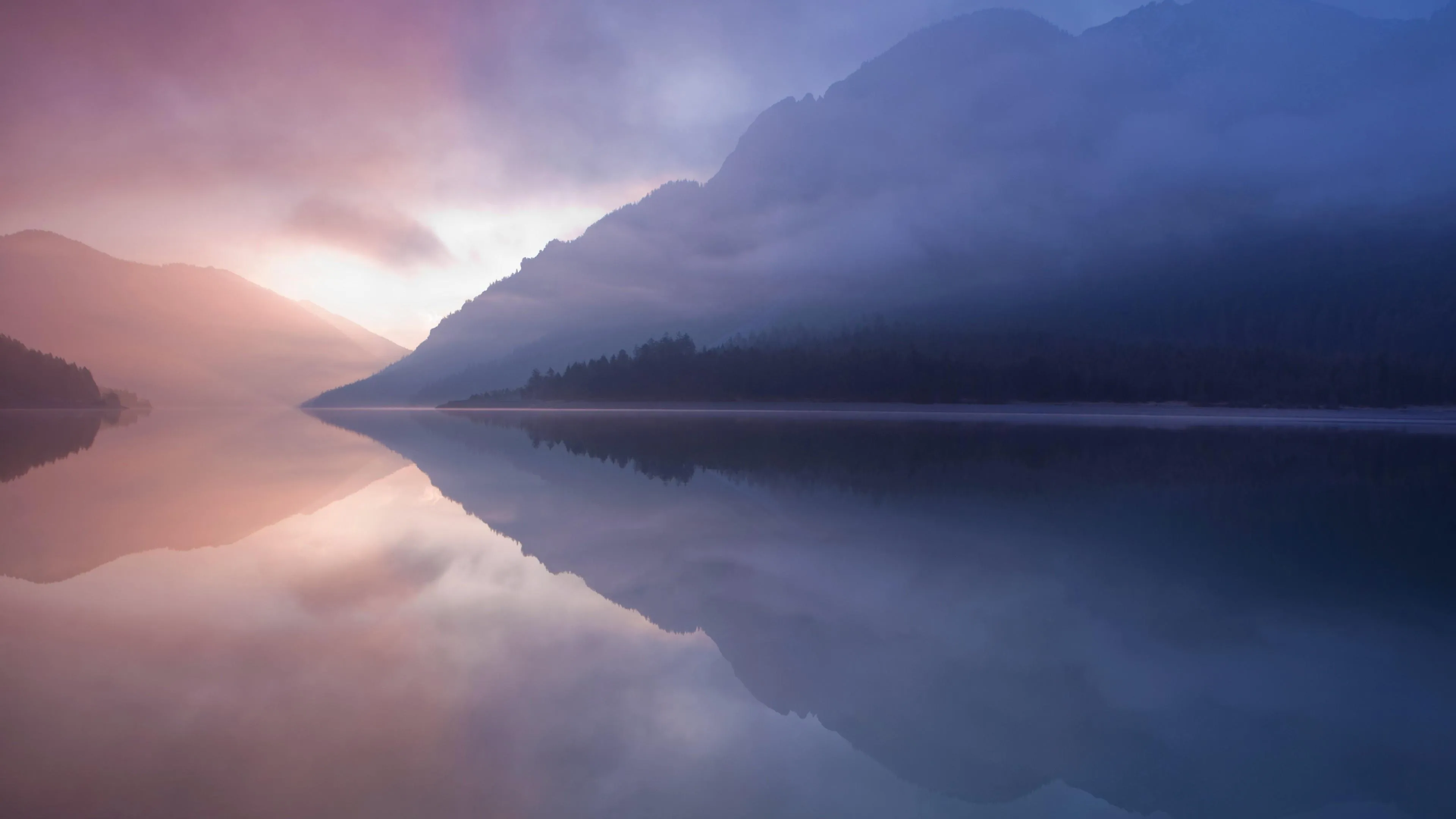 Peaceful Misty Lake with Mountains in Soft Purple Tones