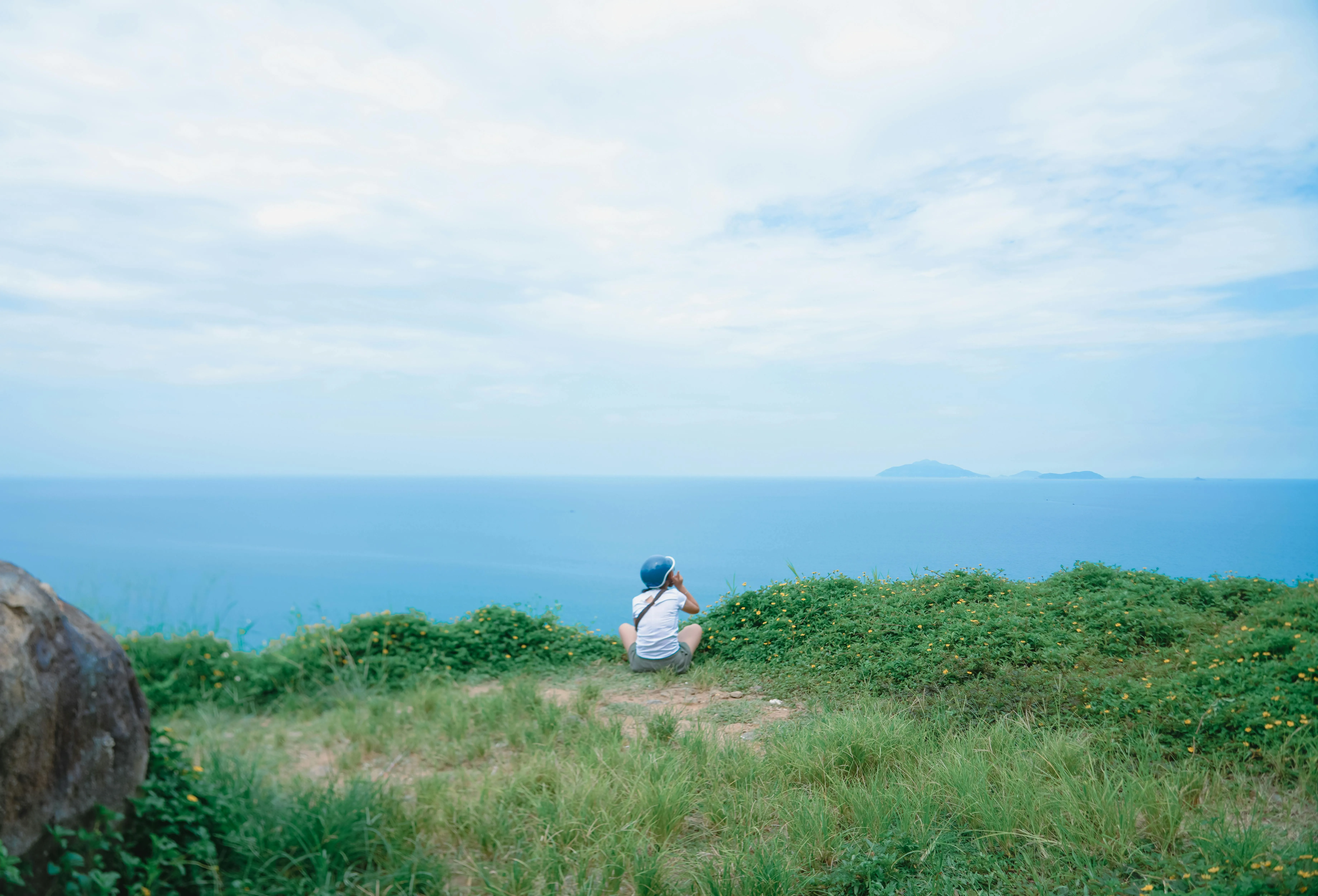 Person Relaxing on a Mountain Top Download Free Wallpaper