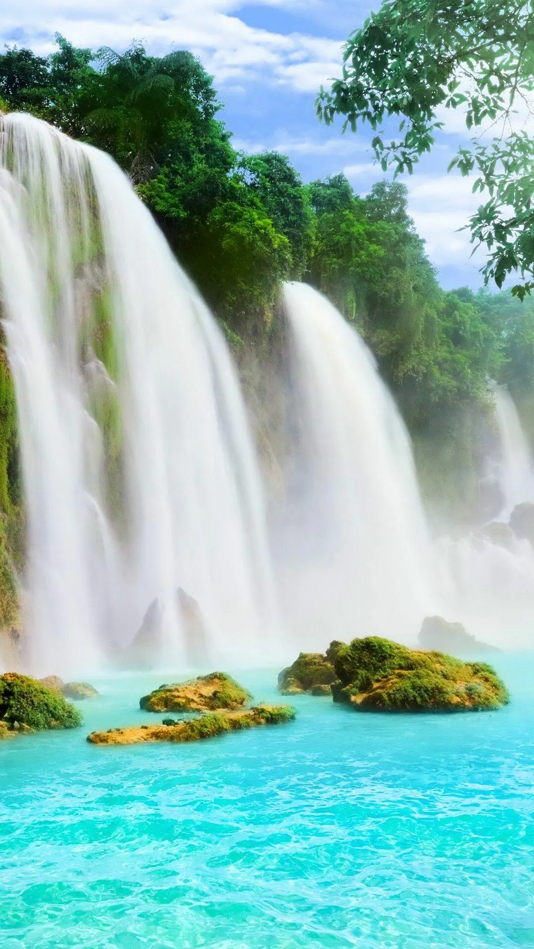 Powerful Tropical Waterfall Flowing into a Bright Blue Lake