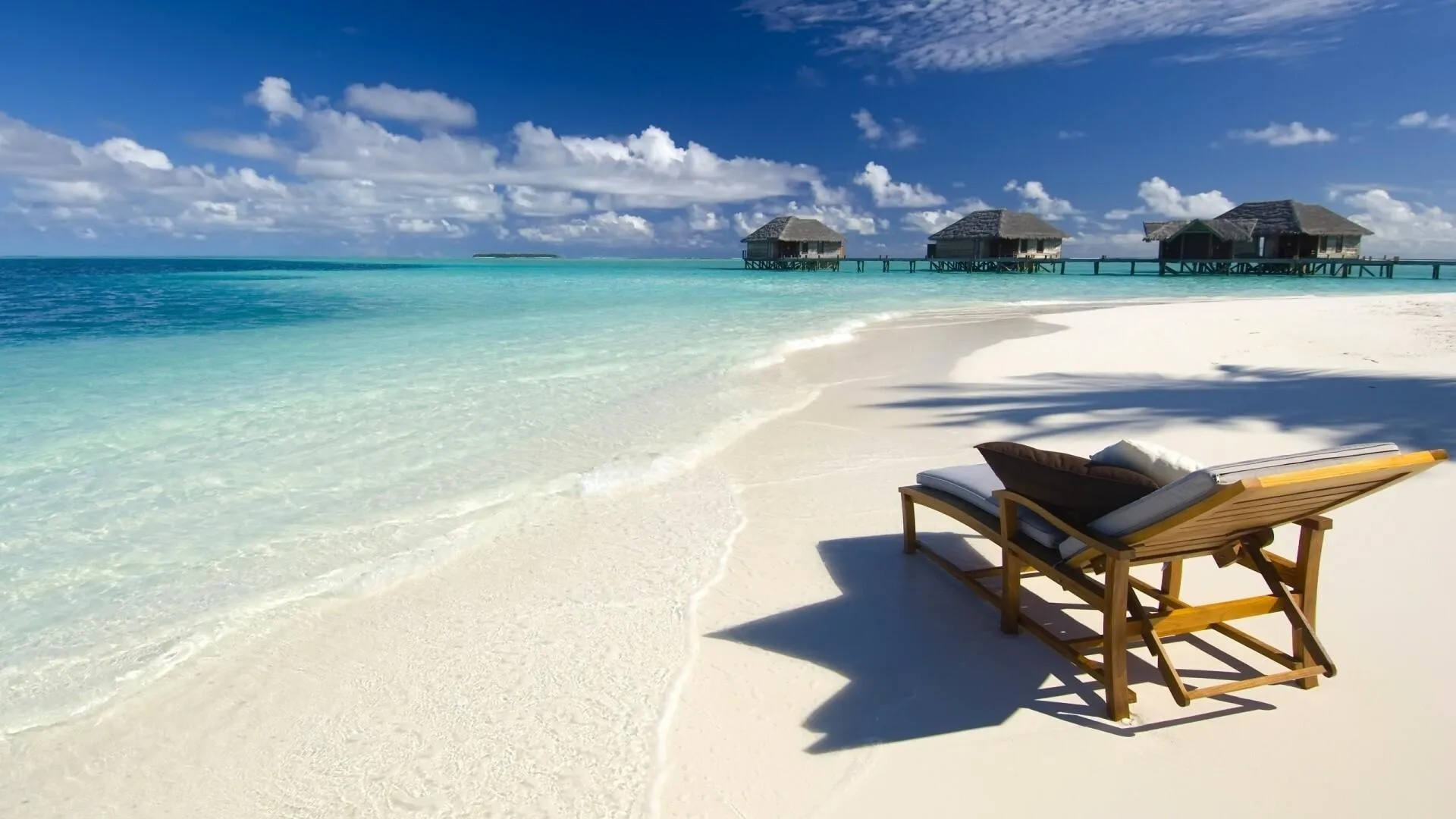 Relaxing Beach Lounger Facing White Sand and Calm Sea