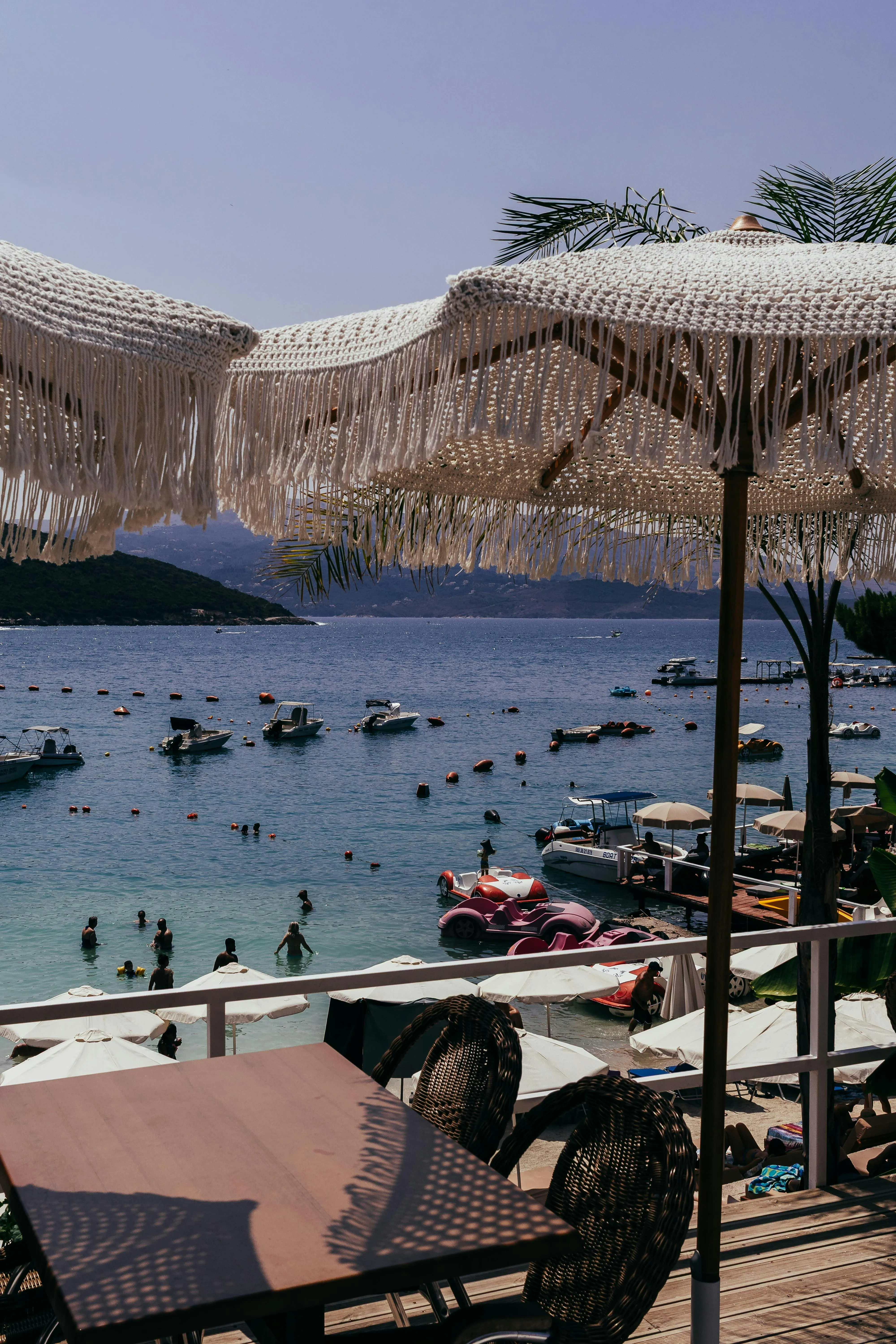 Relaxing Beach Umbrellas Beside Boats on a Sunny Day