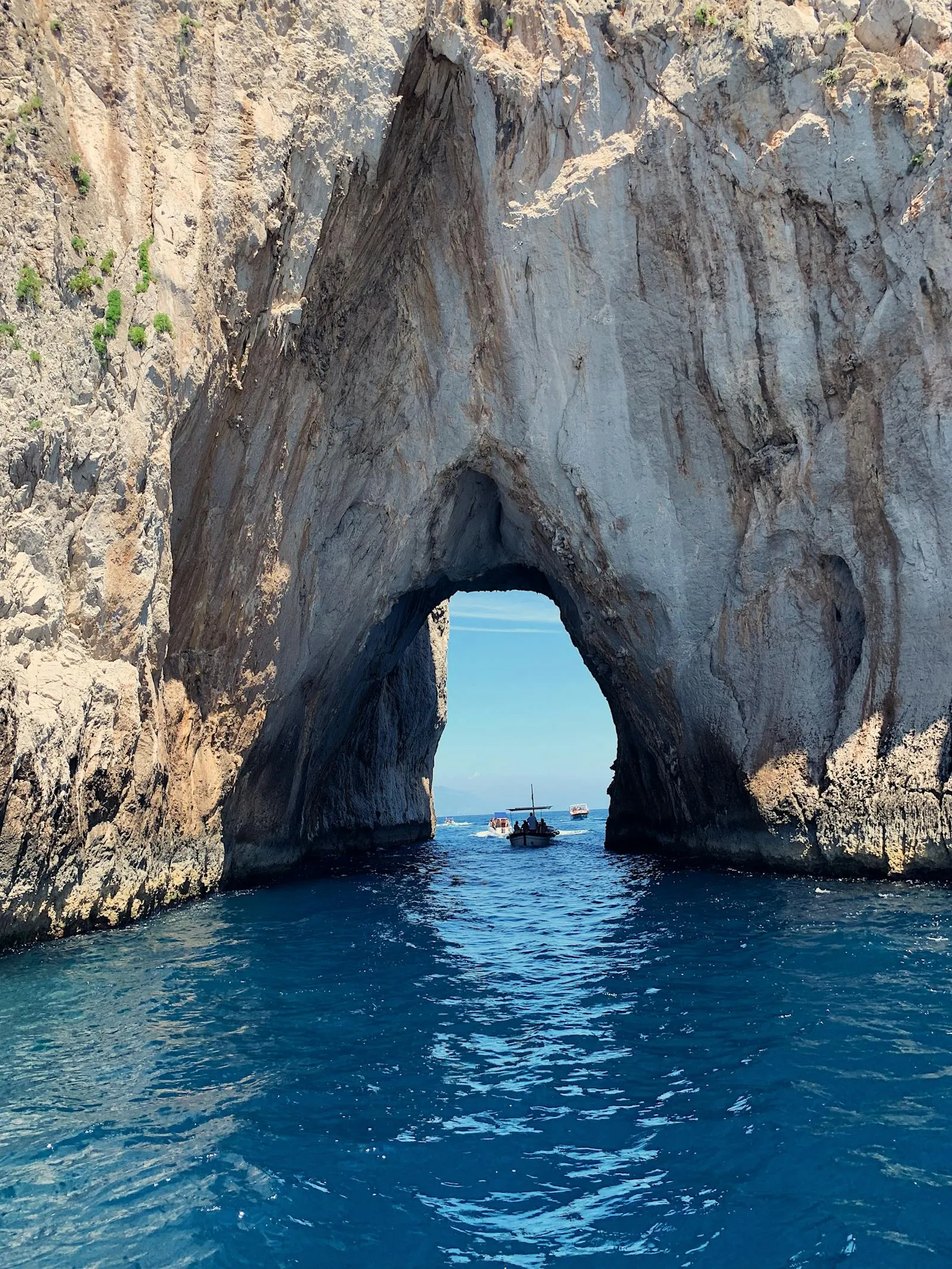 Rock Arch Formation Rising Above Deep Blue Coastal Waters