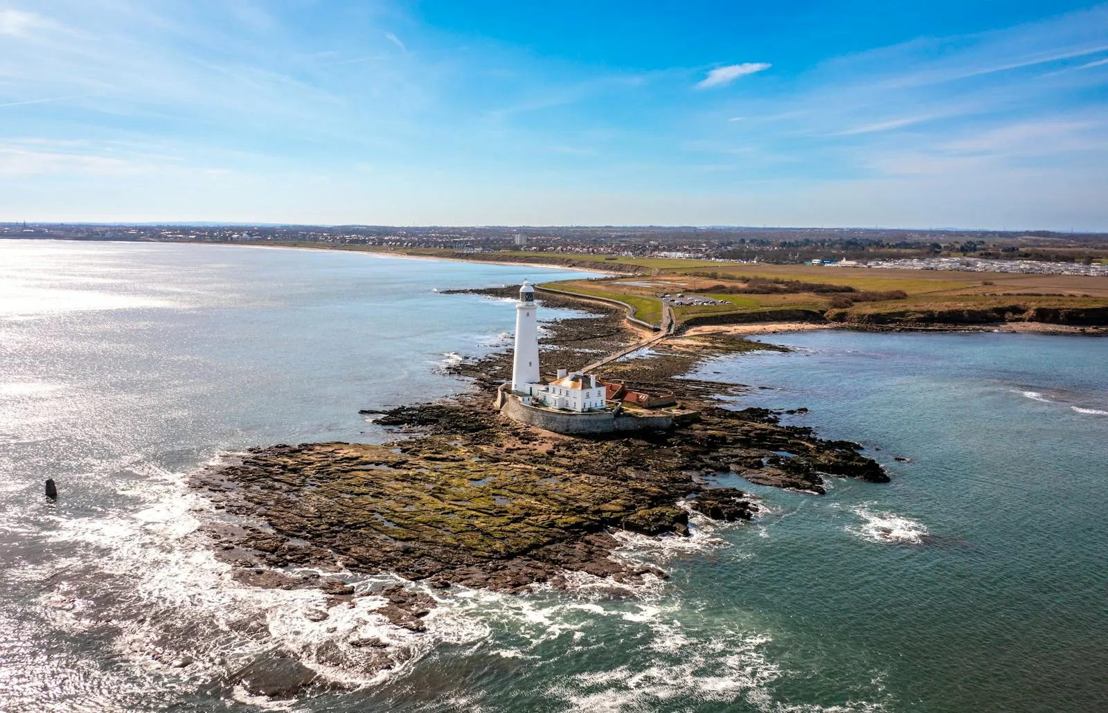 Rocky Island Coastline Surrounded by Peaceful Clear Ocean