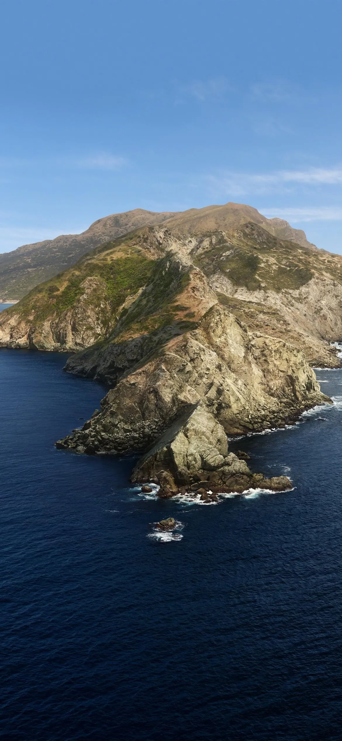Rocky Island with Deep Blue Ocean Under a Clear Sky