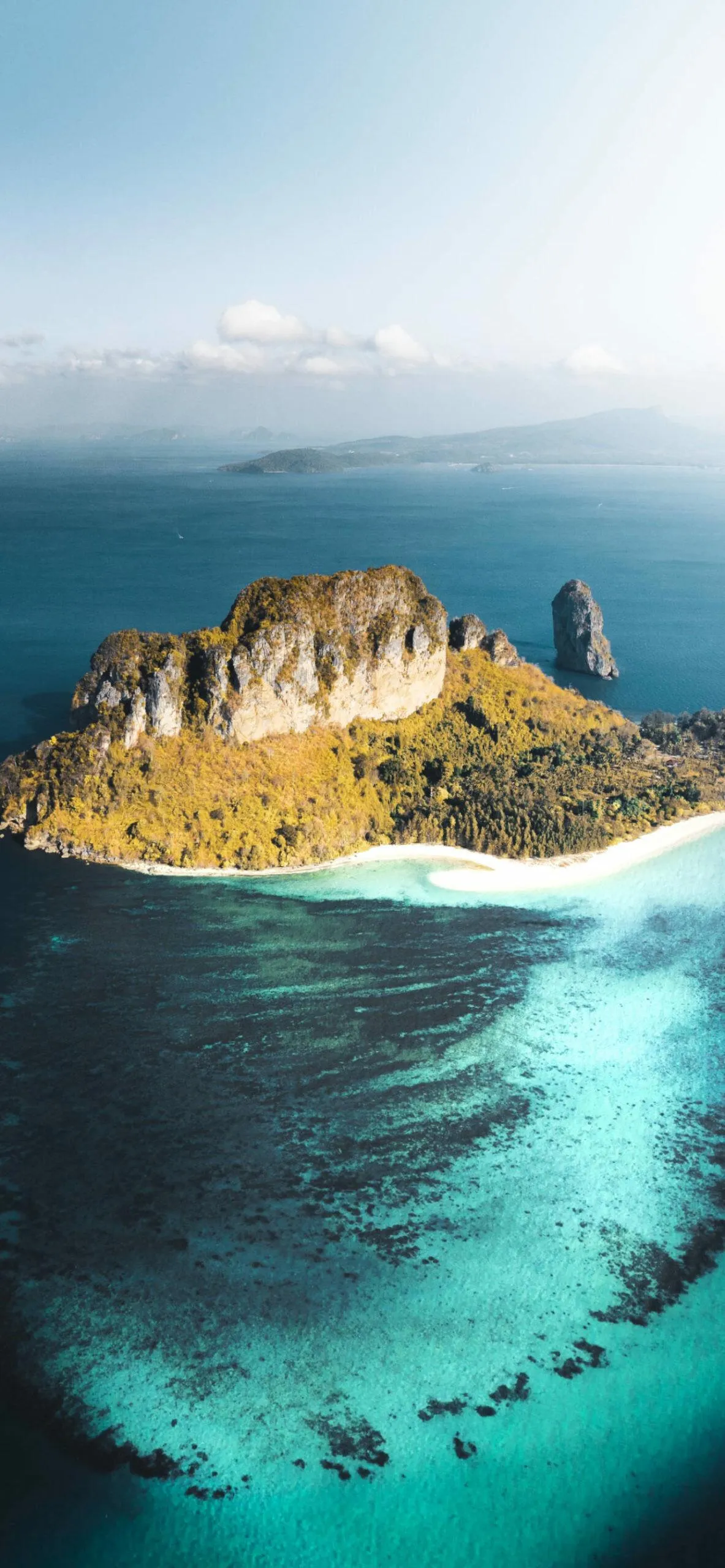 Rocky Island with White Sandy Shore in Deep Blue Water
