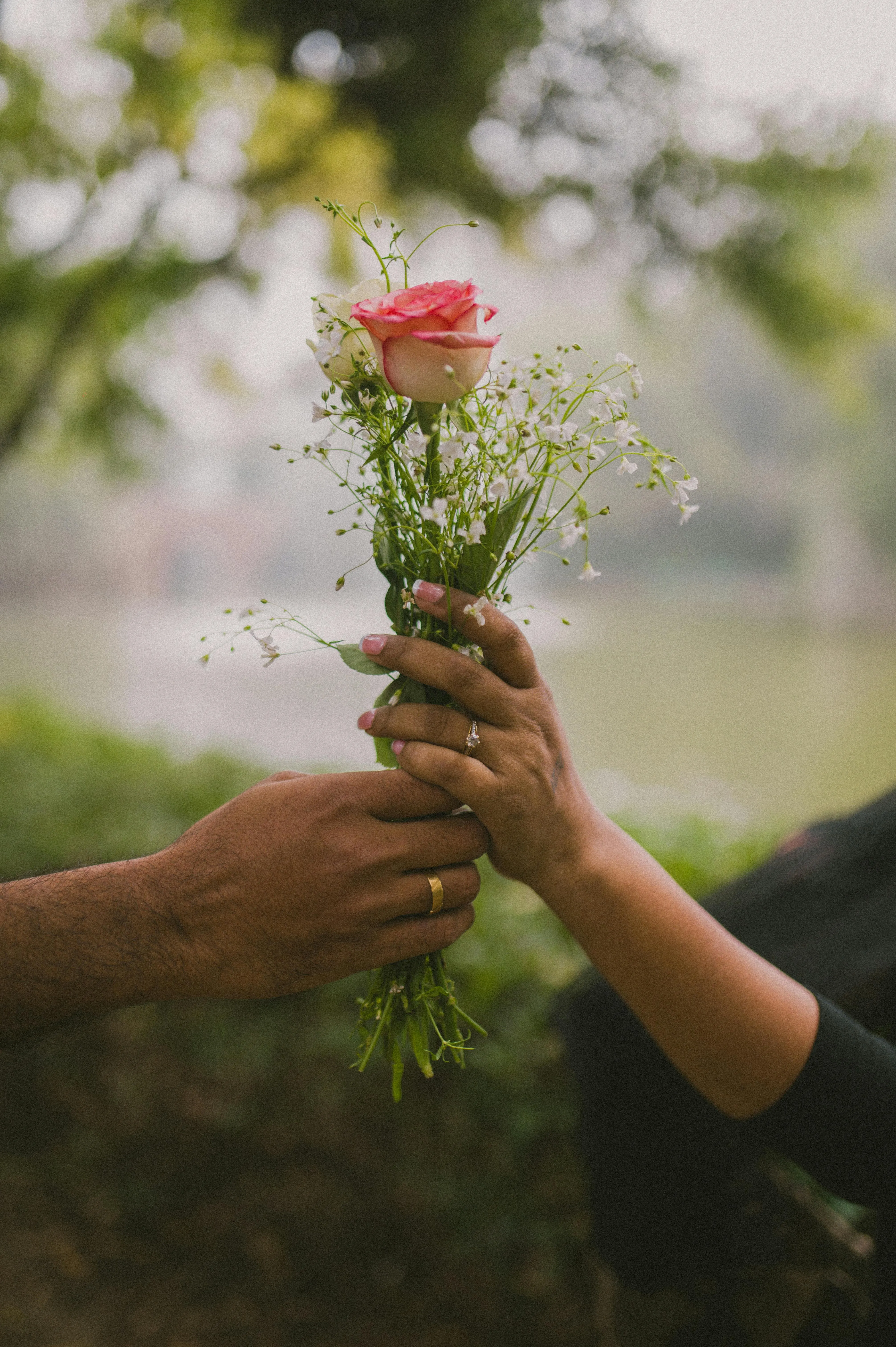 Romantic Moment of a Couple Exchanging Flowers Wallpaper