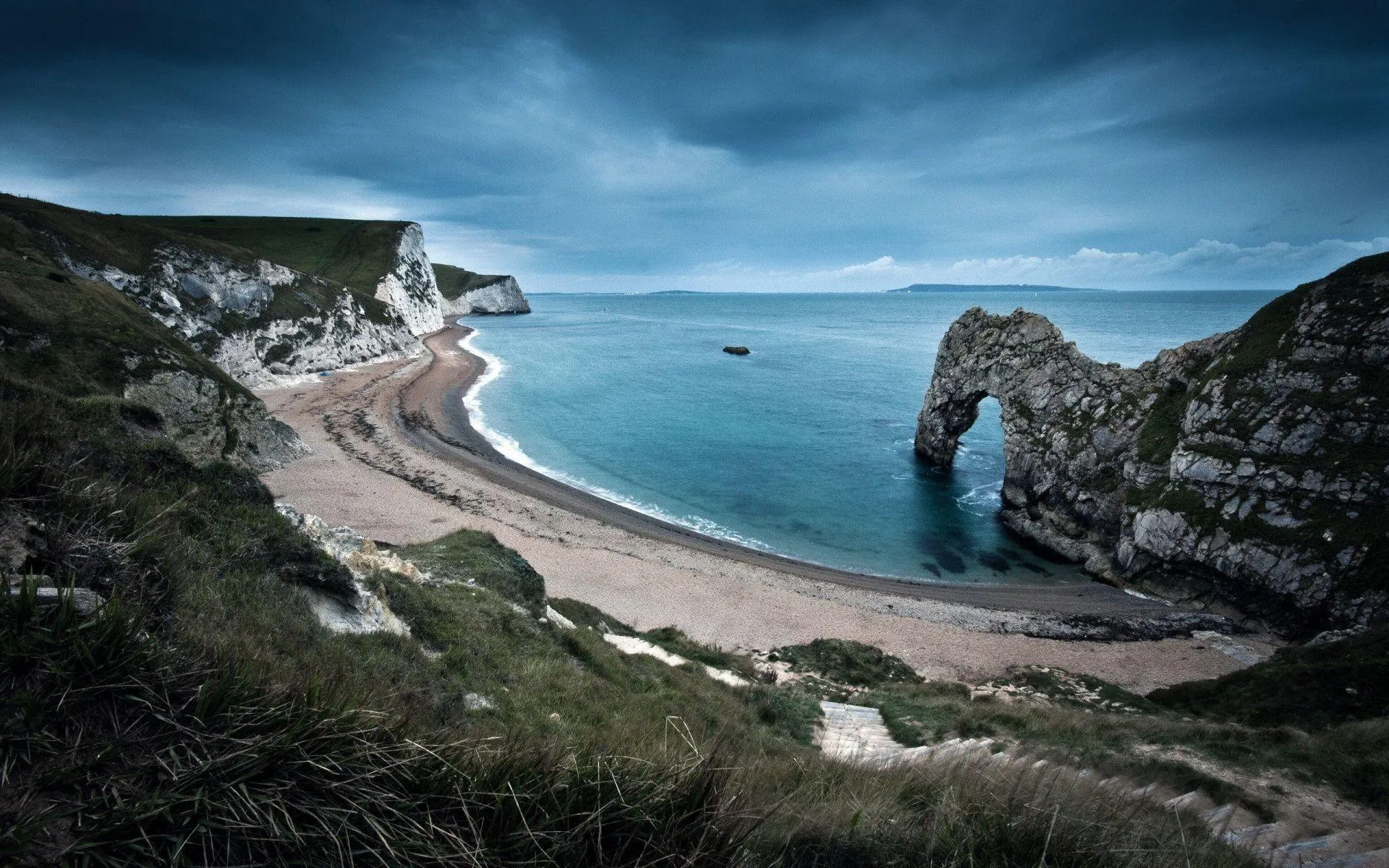 Rugged Cliff Coastline Curving Around a Quiet Sandy Beach