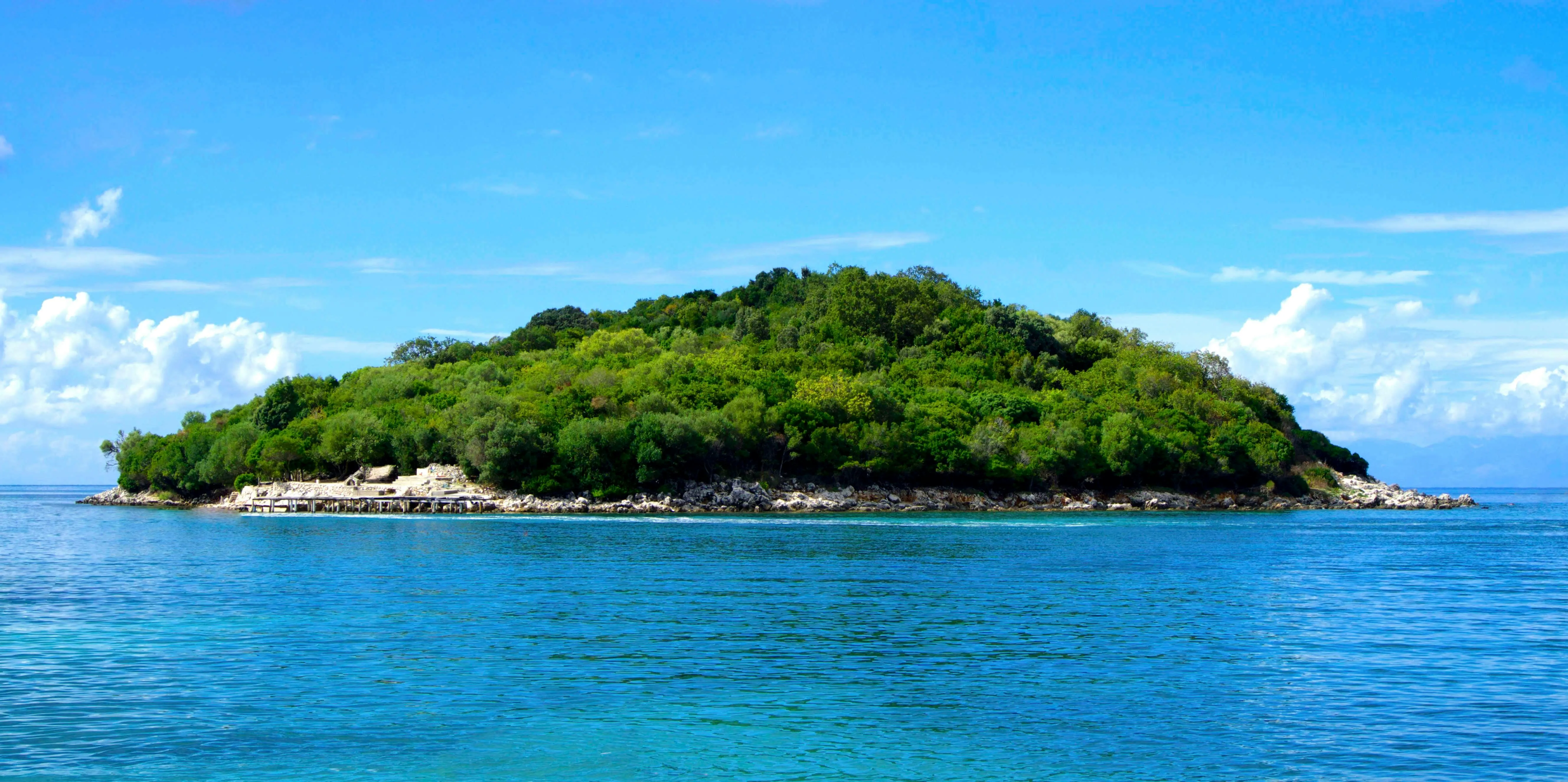 Side View of a Small Island Surrounded by Clear Ocean