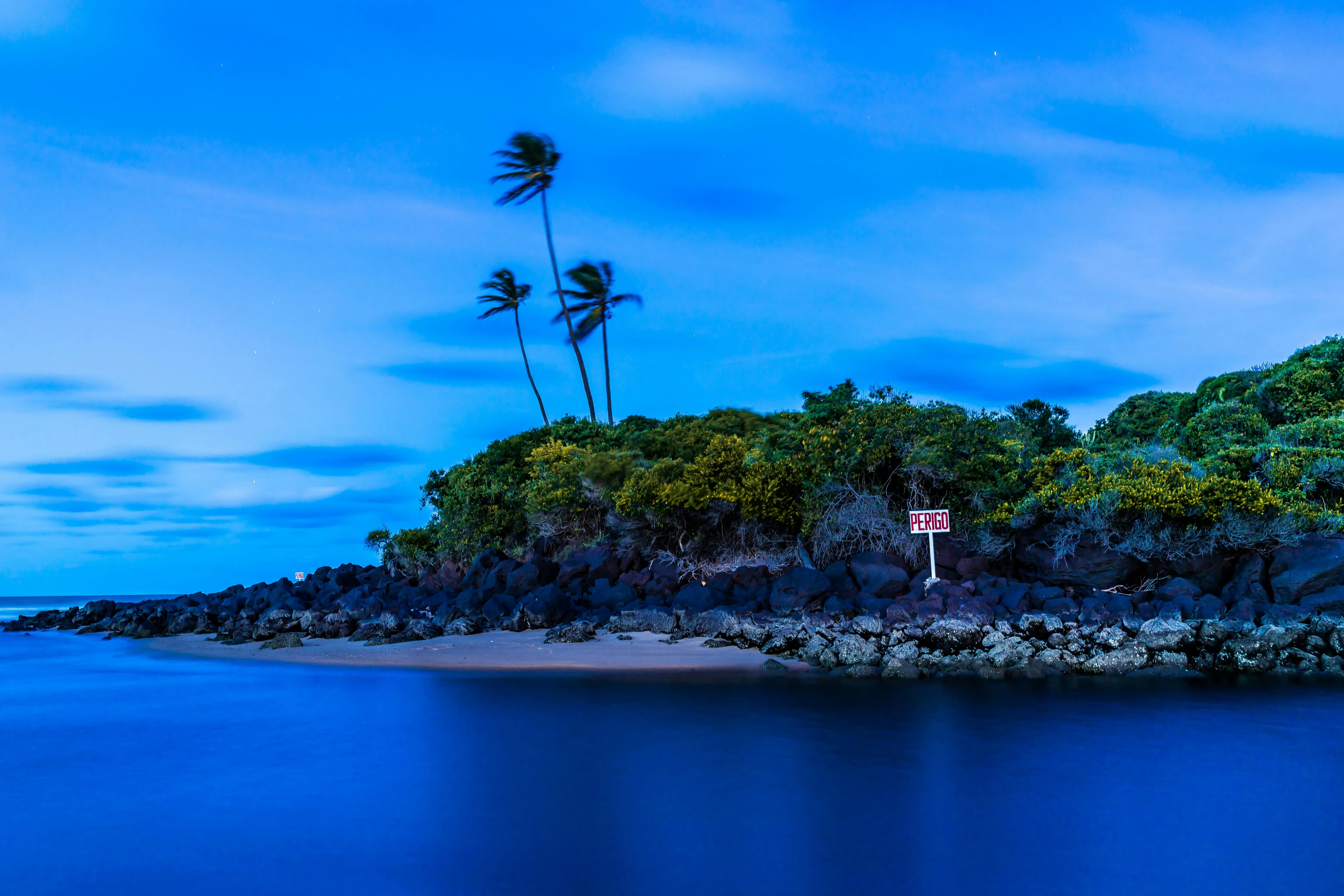 Small Island with Palm Trees Under a Blue Evening Sky