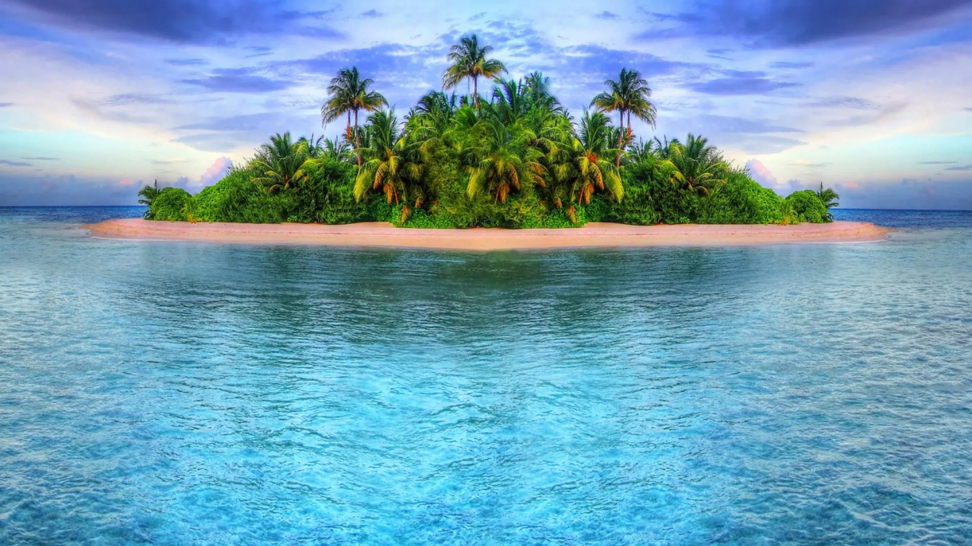 Small Tropical Island Surrounded by Blue Seawater Wallpaper