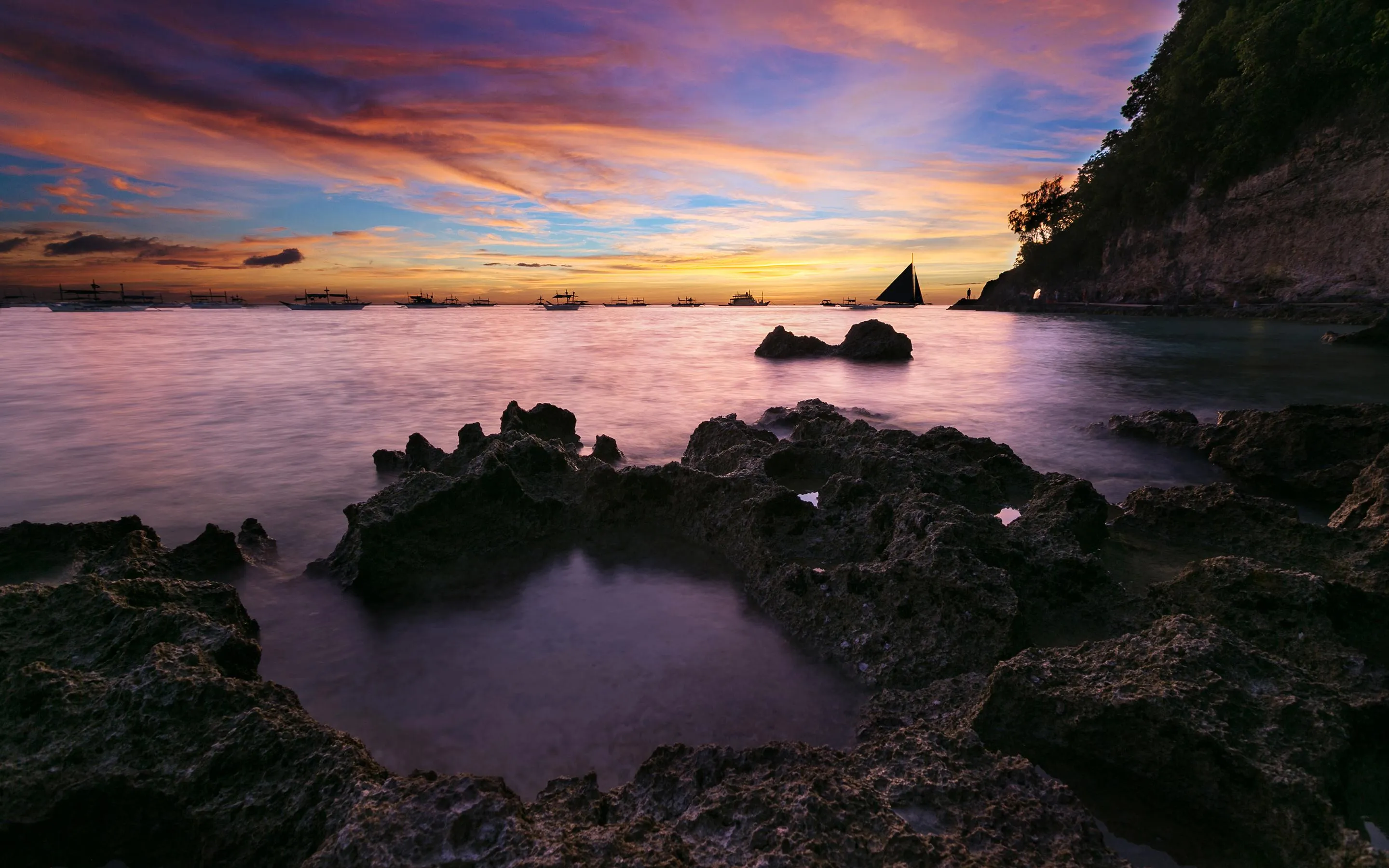Smooth Stones Along the Coast Under Vibrant Skies Wallpaper