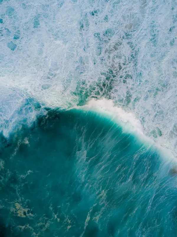 Stunning Top View of an Ocean Wave Crashing in the Blue Sea