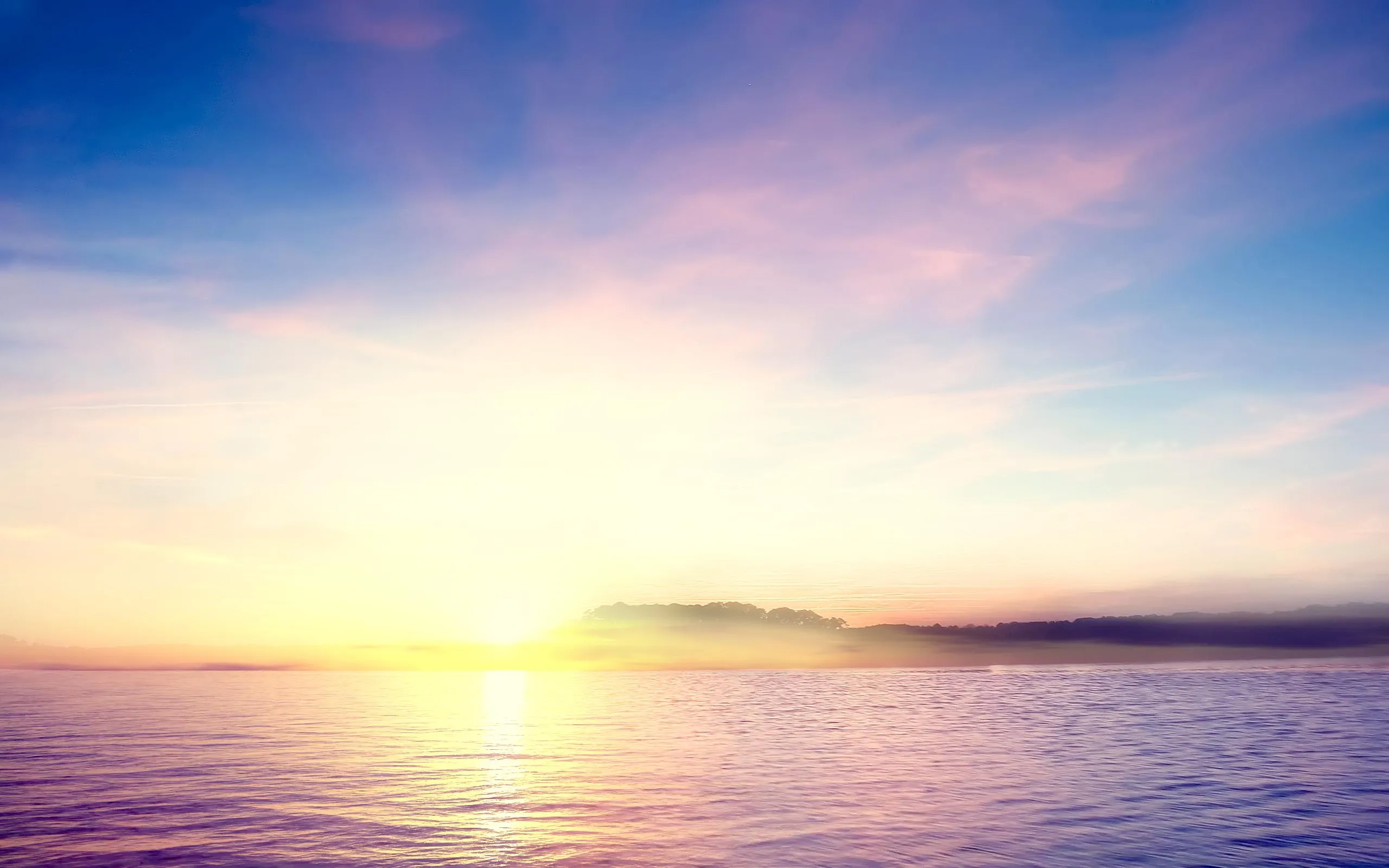 Sunrise over Calm Ocean with Soft Glowing Light on Water