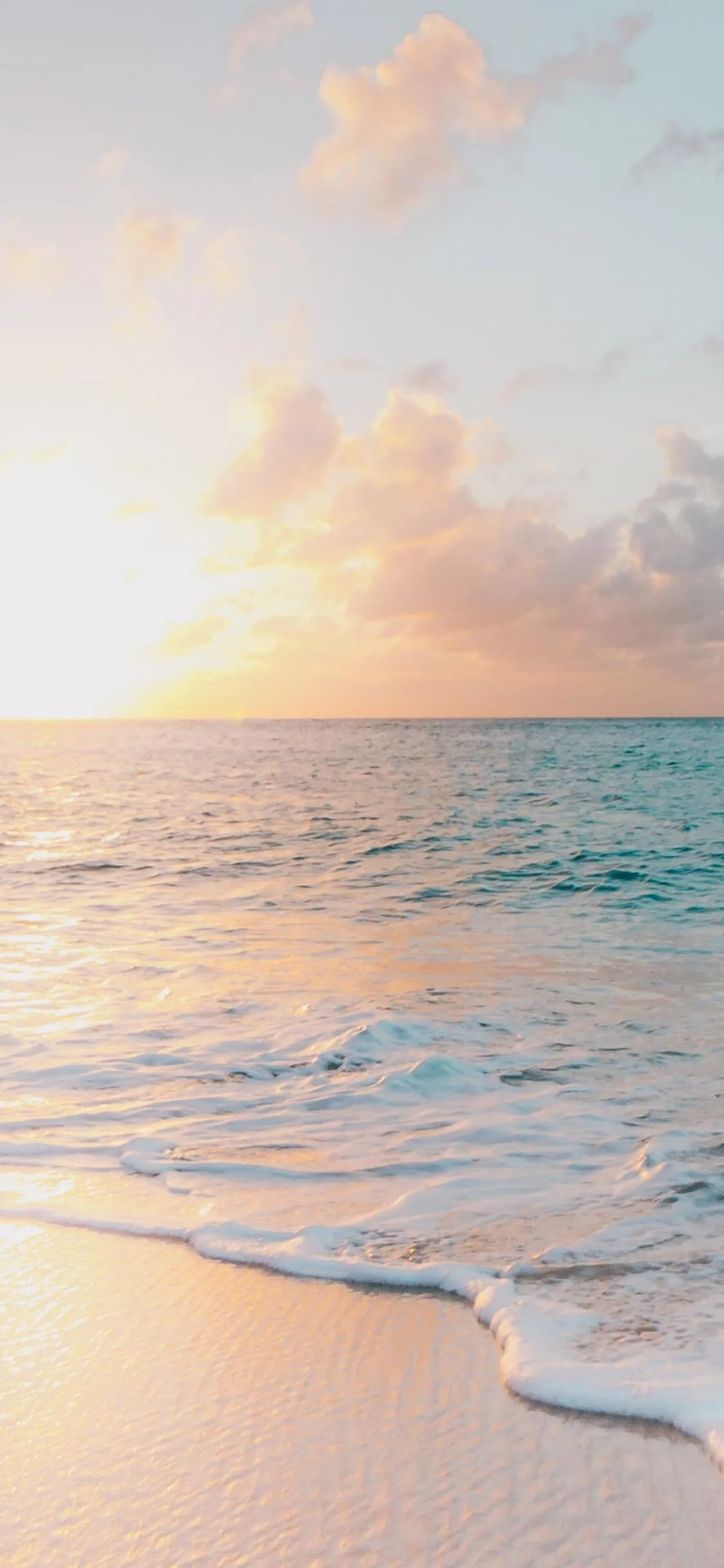 Sunset Light on the Beach with Small Gentle Water Waves