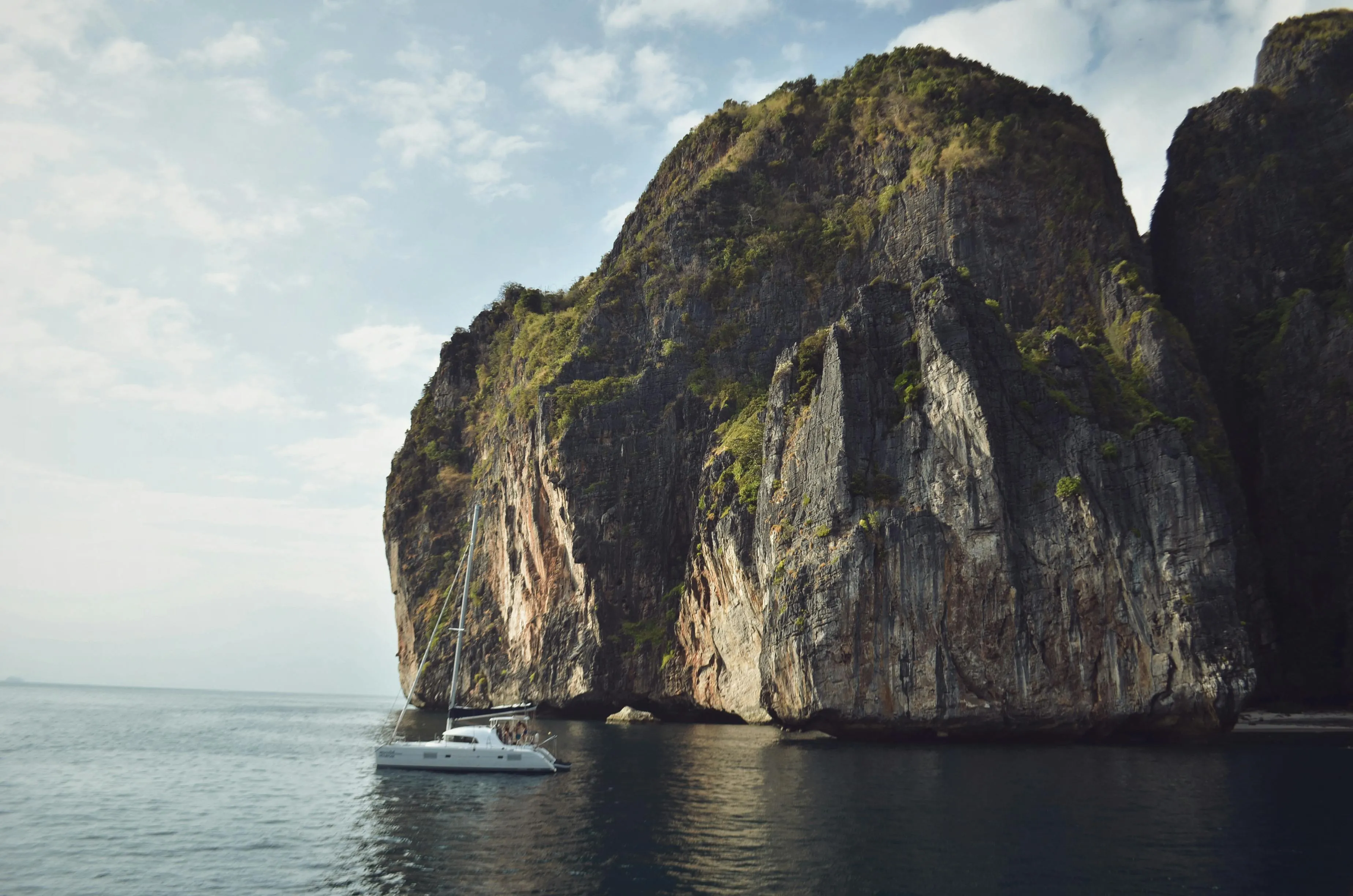 Tall Limestone Cliffs Rising from a Calm Deep Blue Ocean