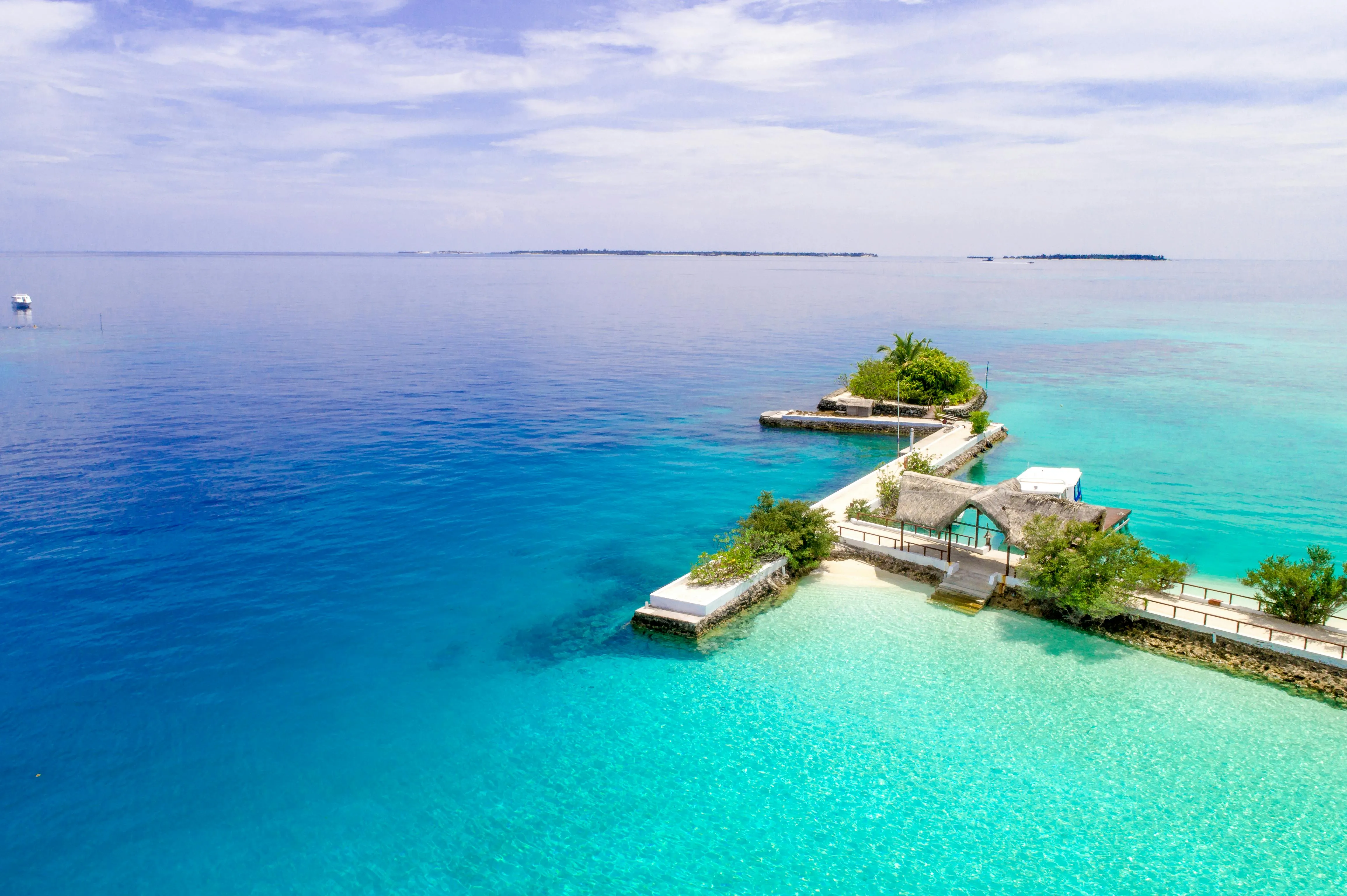 Tiny Resort Island Surrounded by Clear Blue Ocean Wallpaper