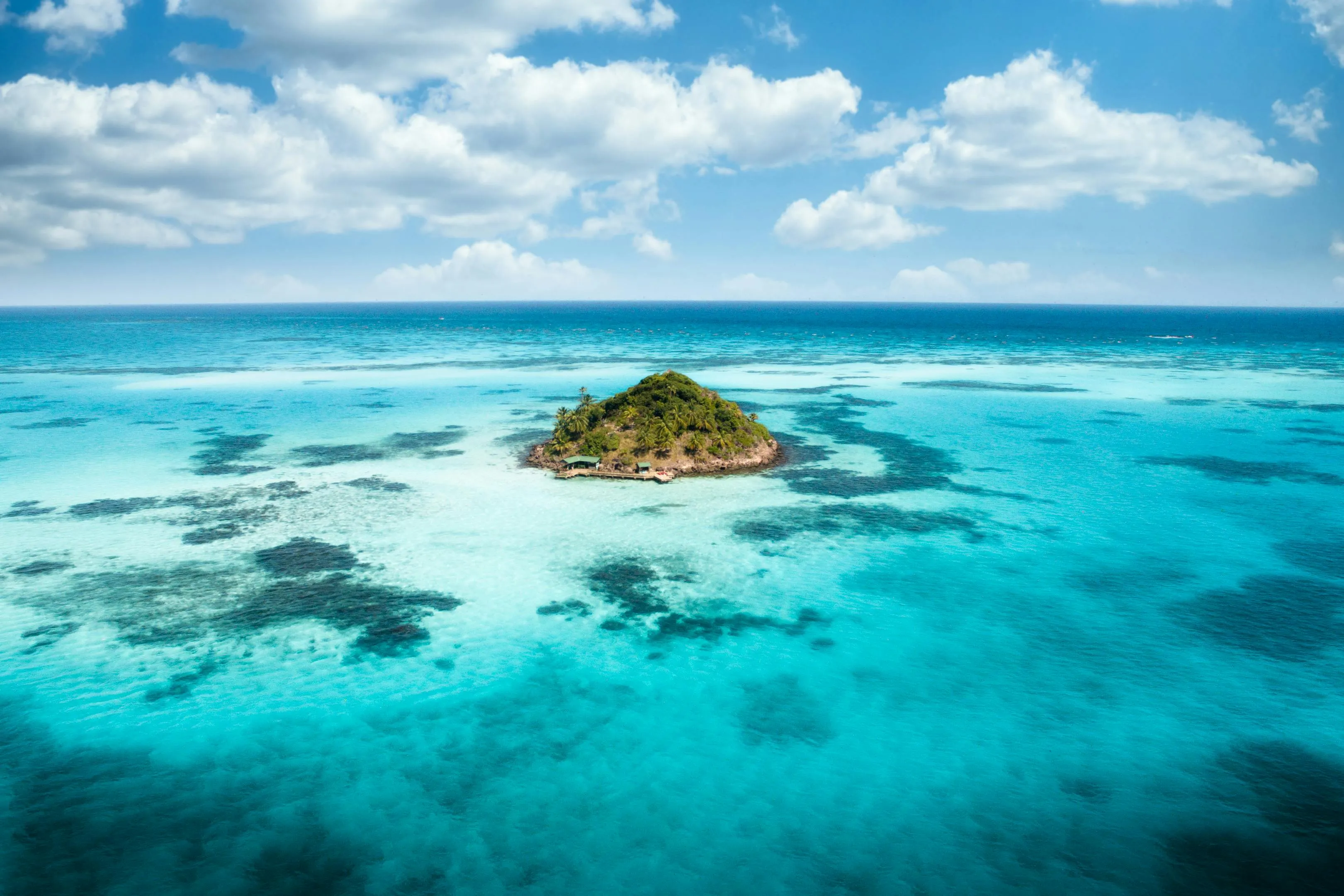 Tiny Tropical Island Surrounded by Clear Sea Water Wallpaper