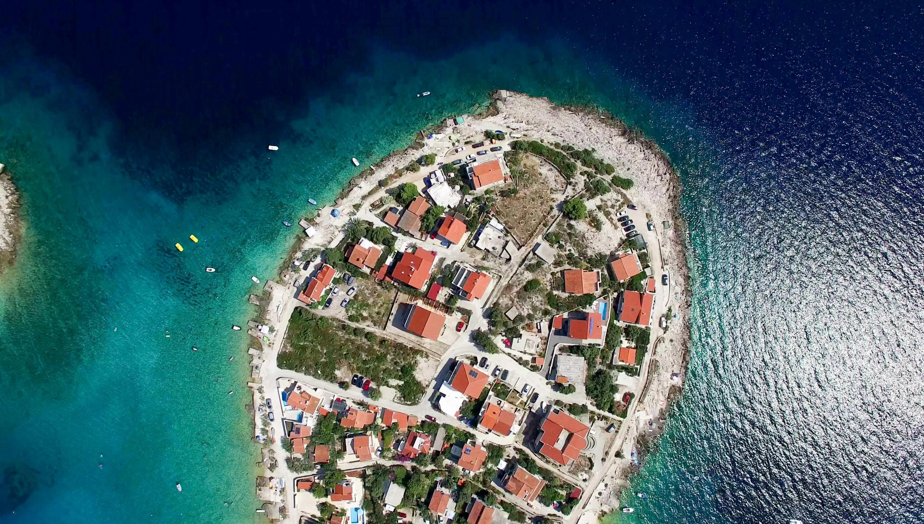Top View of a Circular Island with Houses and the Ocean