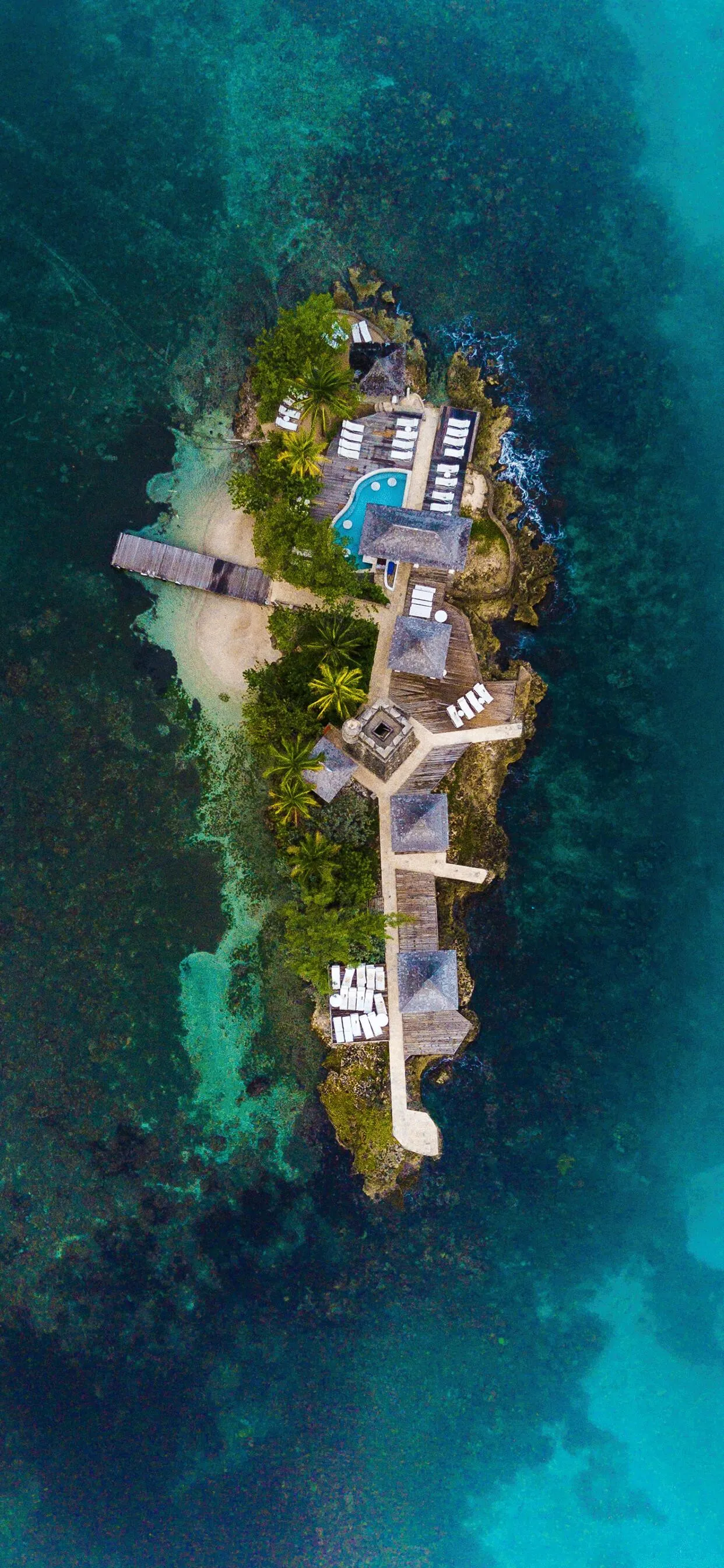 Top View of a Private Island with Villas and Blue Ocean