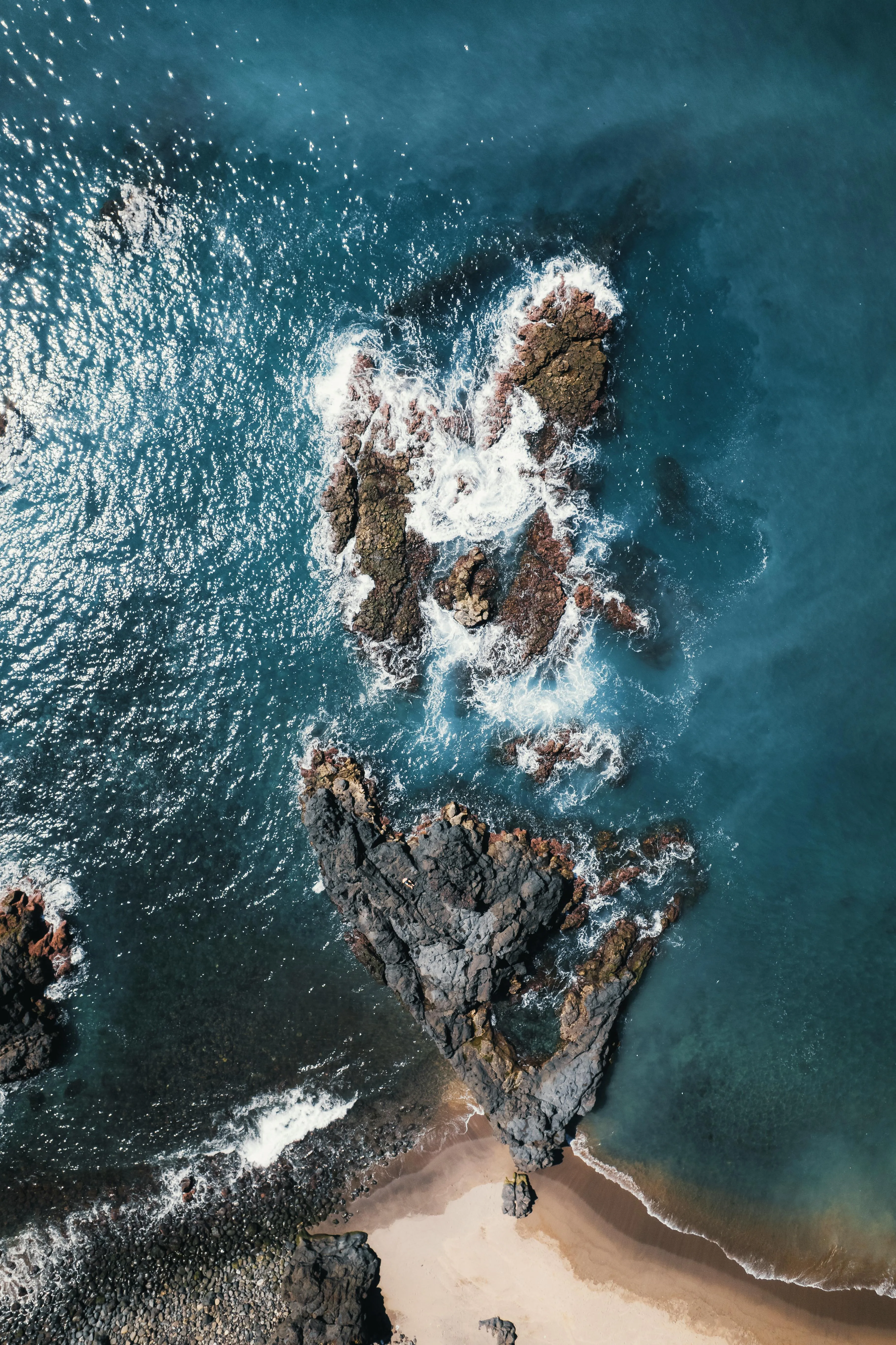 Top View of Rocky Coastline and Turquoise Ocean Waves