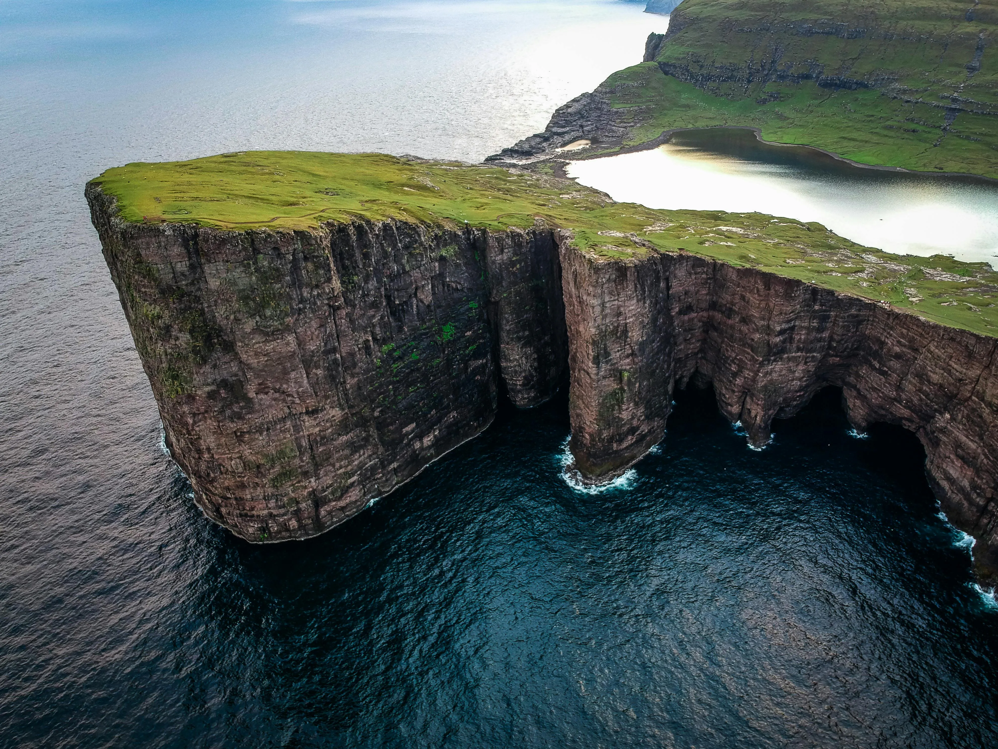 Towering Cliffs and the Ocean Edge from an Aerial Angle