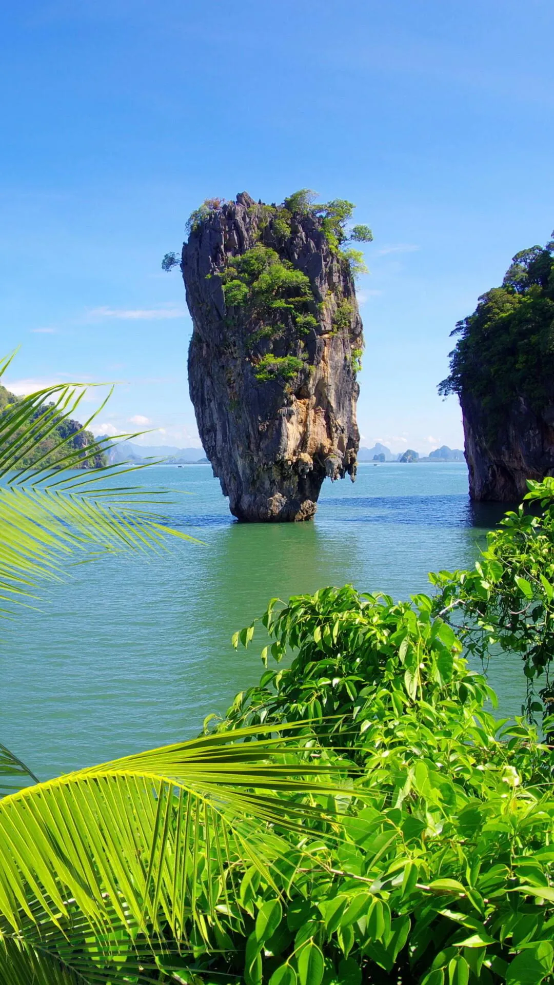 Towering Rock Island with a Tropical Forest Free Wallpaper