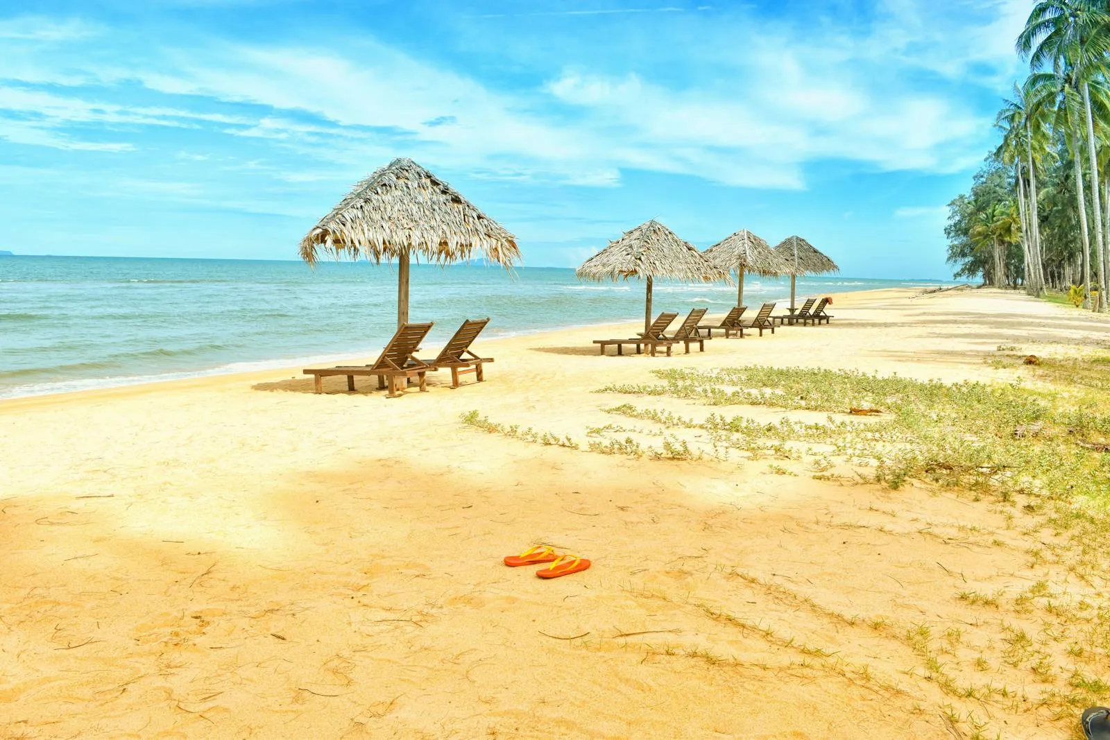 Tropical Beach Loungers with Umbrellas on Golden Sand