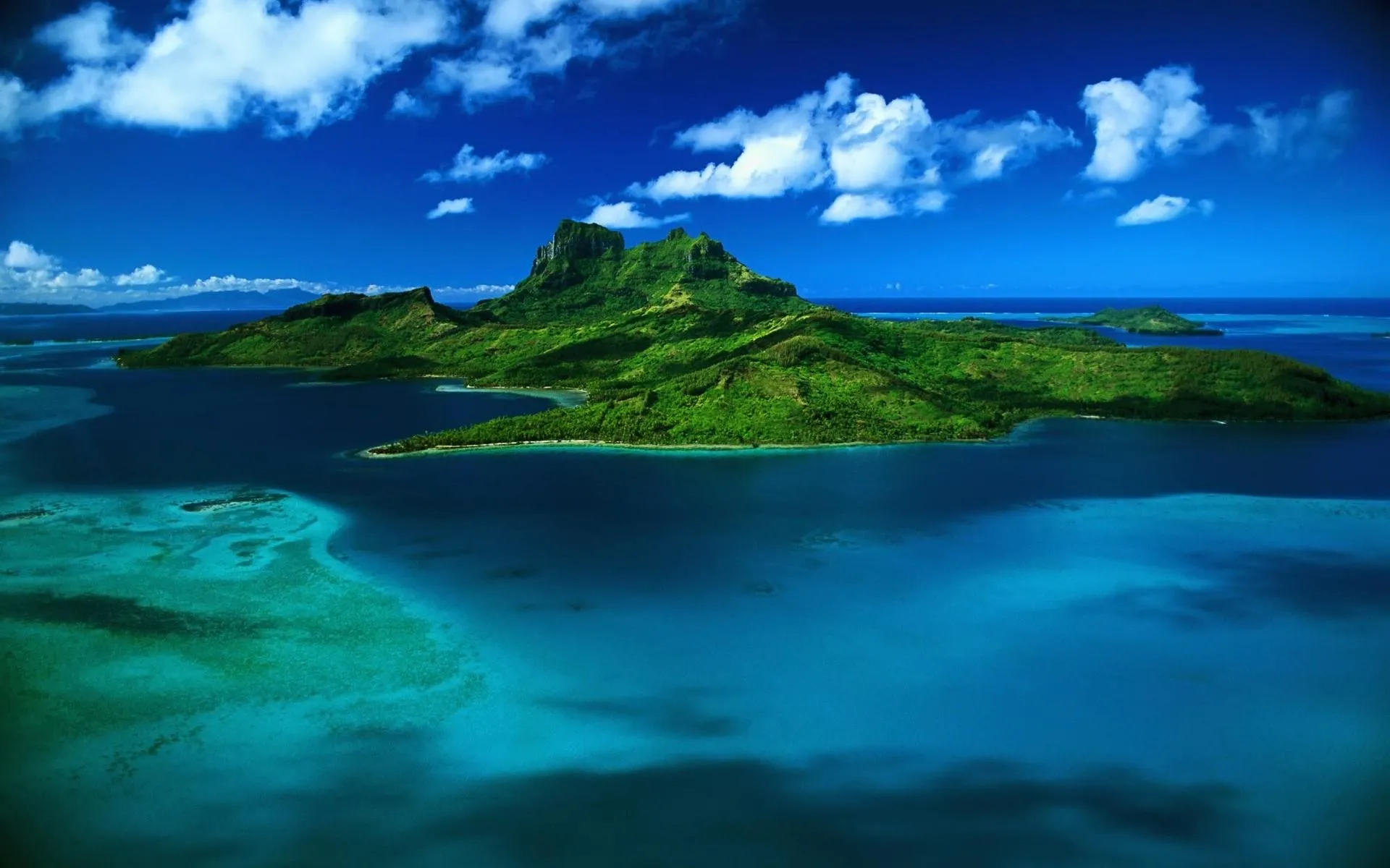 Tropical Island Surrounded by Blue Ocean Waters Wallpaper