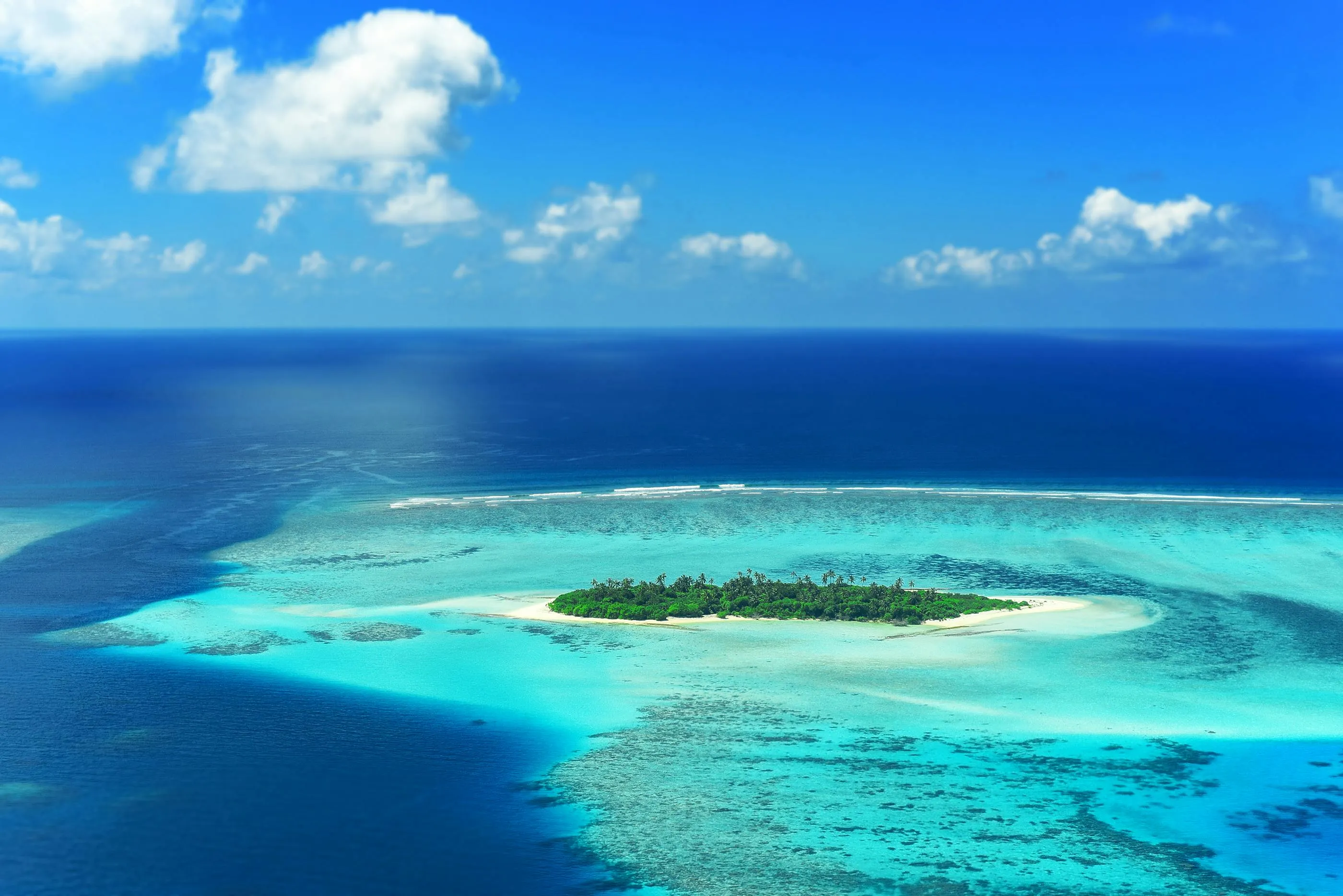 Tropical Island Surrounded by Coral Reefs Free Wallpaper