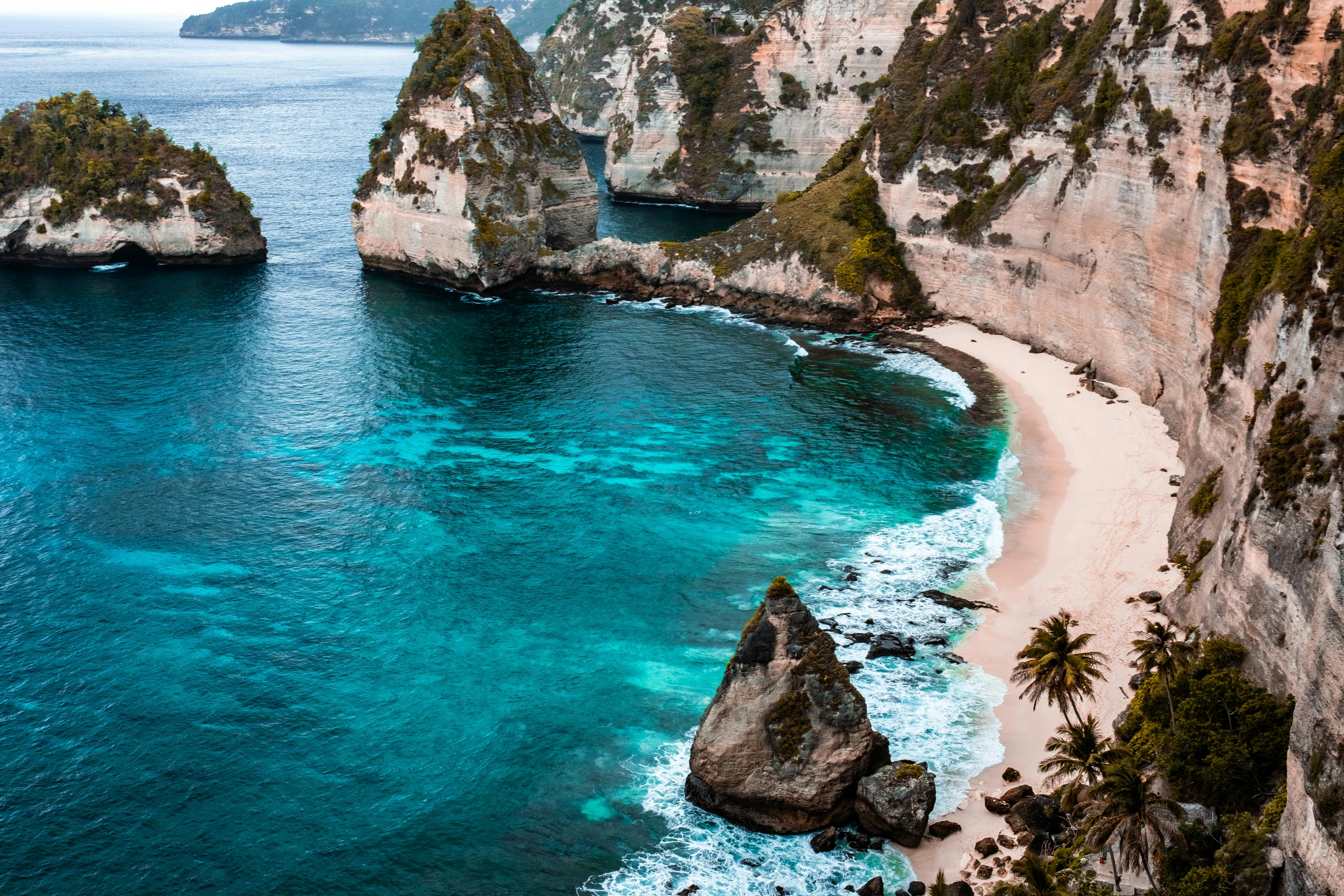 Turquoise Water with Rocky Cliffs on the Sunny Beach