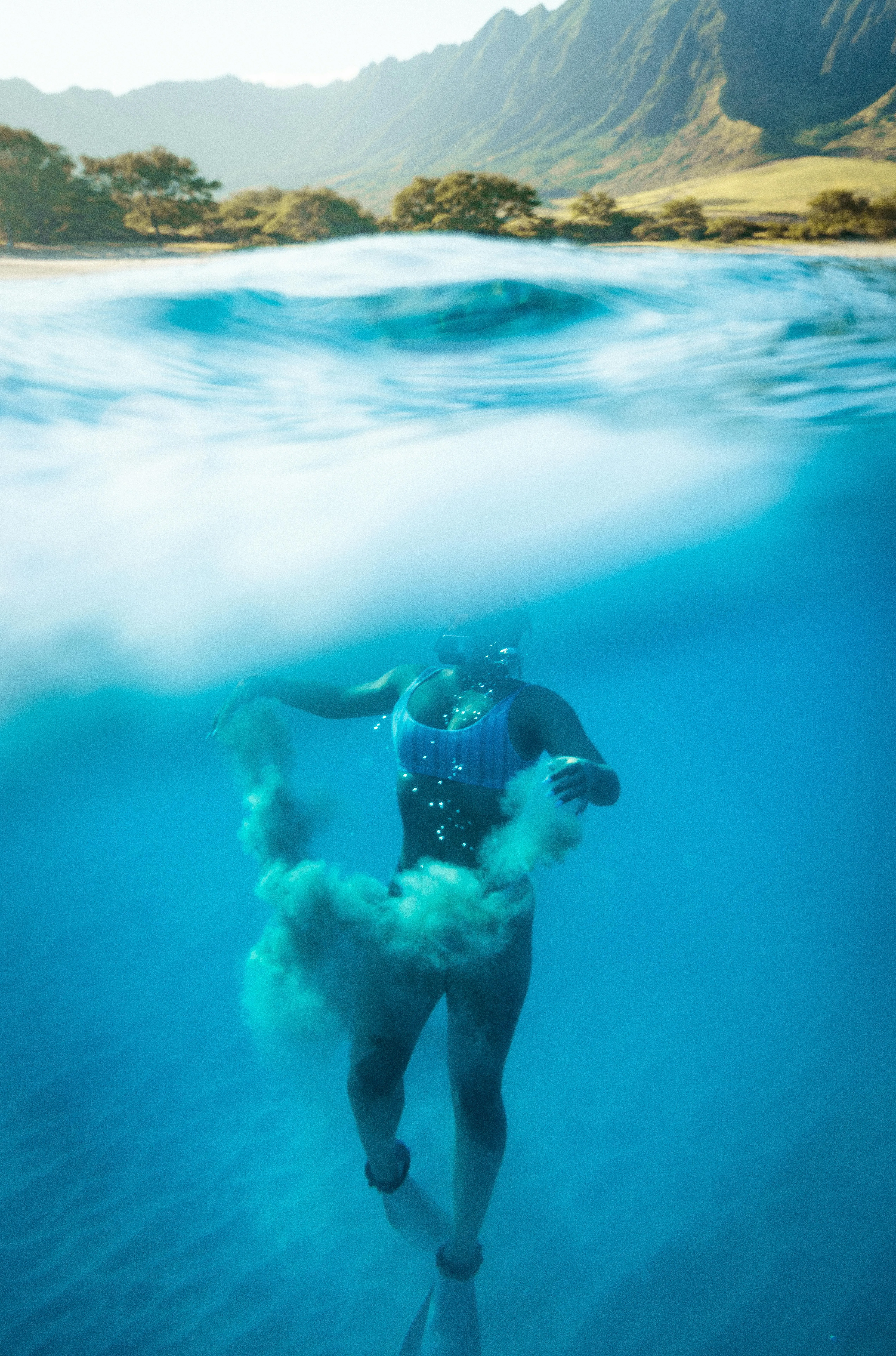 Underwater View of a Swimmer in a Clear Ocean Free Wallpaper