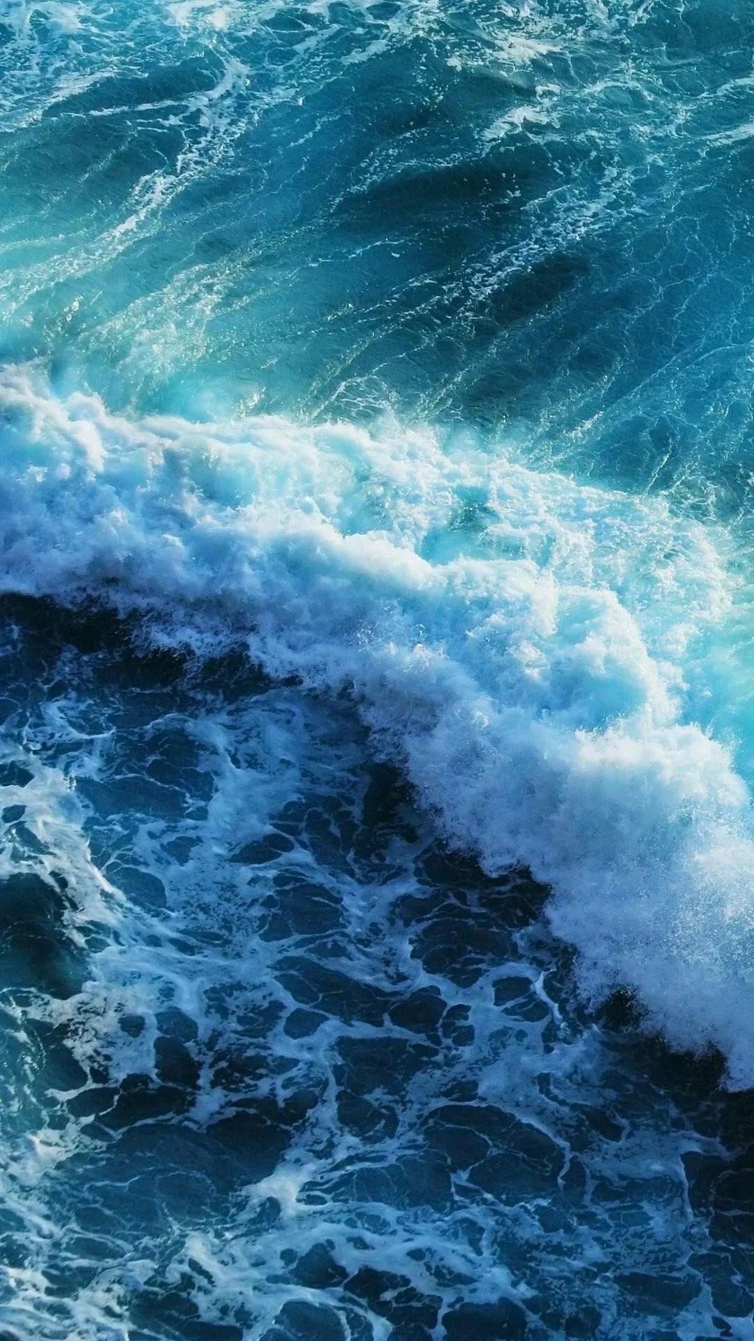 Vibrant Blue Ocean Waves Crashing with White Sea Foam