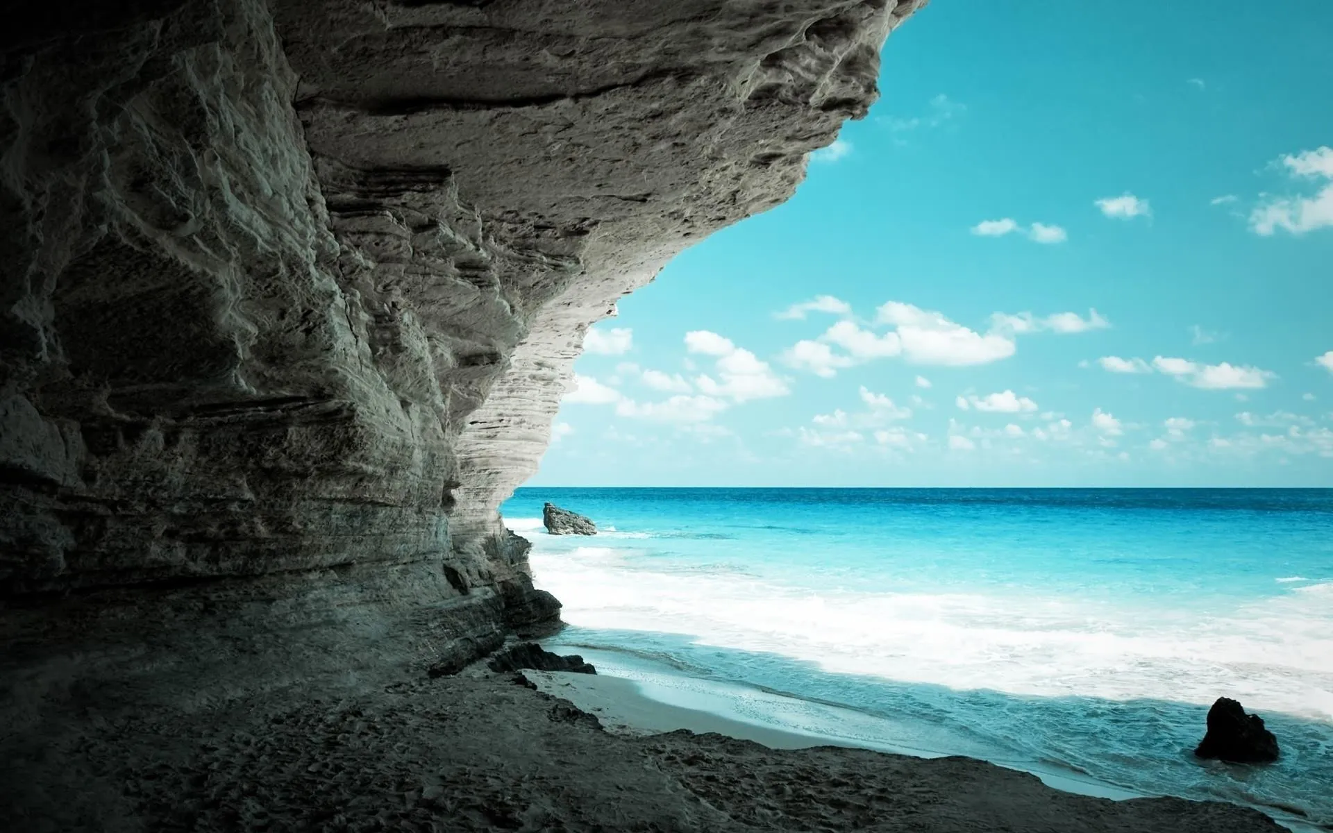 View from Inside the Rocky Cave with the Turquoise Ocean