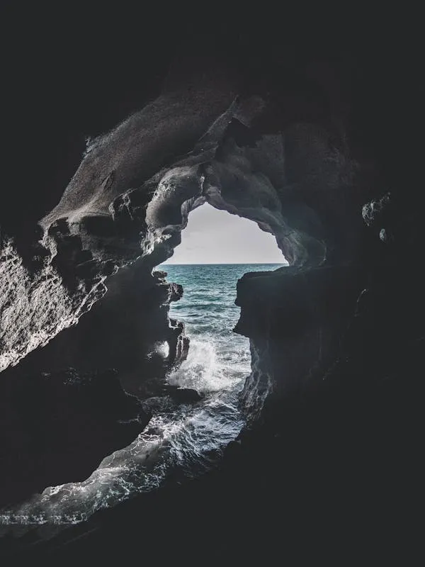 View of the Ocean Through a Rocky Sea Cave Free Wallpaper